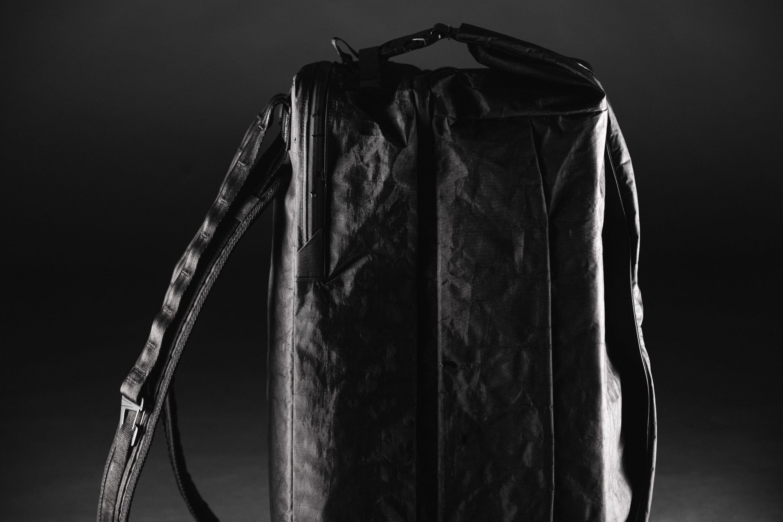 Black Mile Travel Bag Product Photography Side view closeup of a black backpack