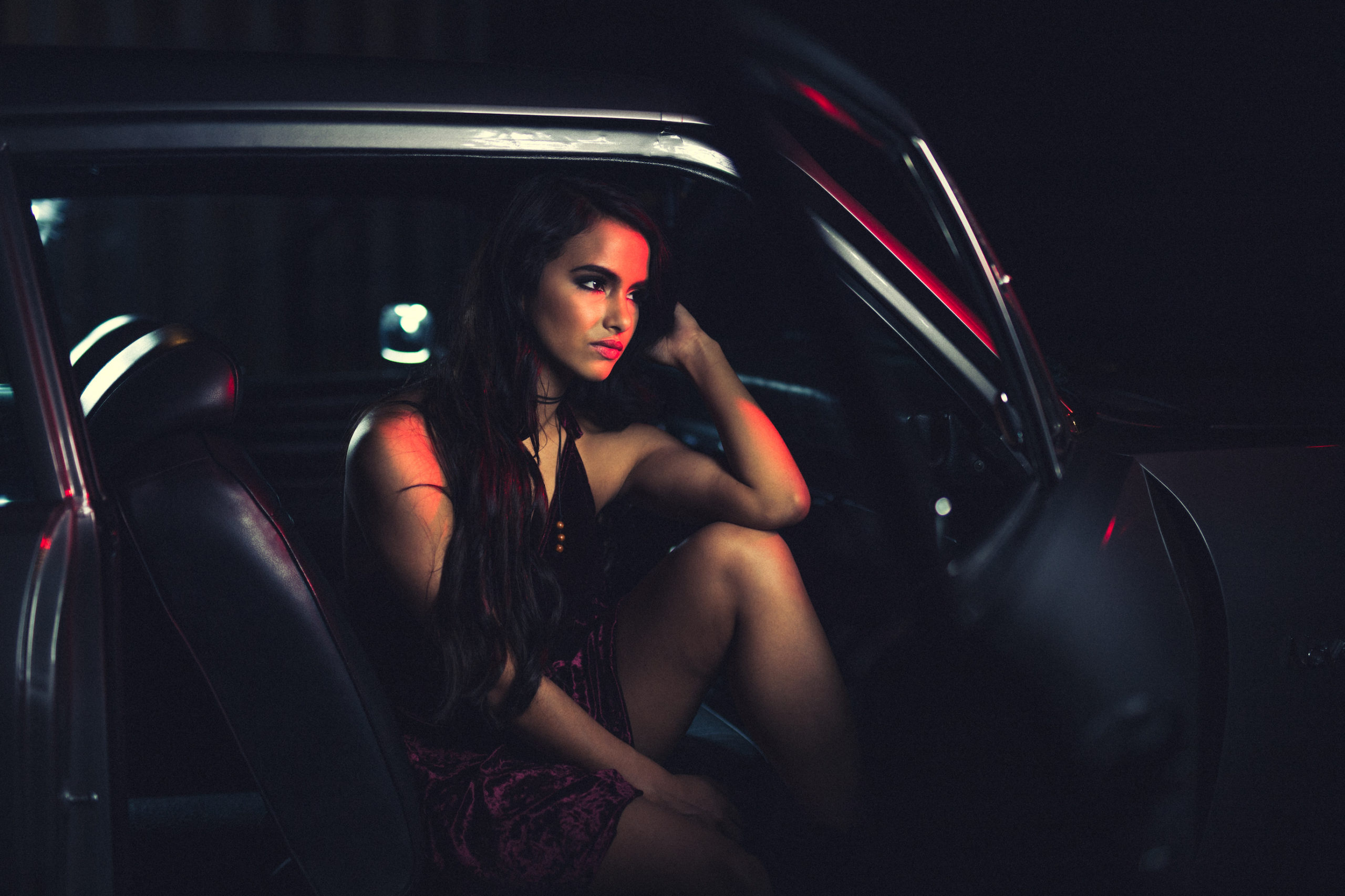 IU Creative Talent Agency Fort Lauderdale Model Profile Mercedes Side profile of woman with long hair wearing lingerie looking off into the distance posing for camera from the front seat of an old car
