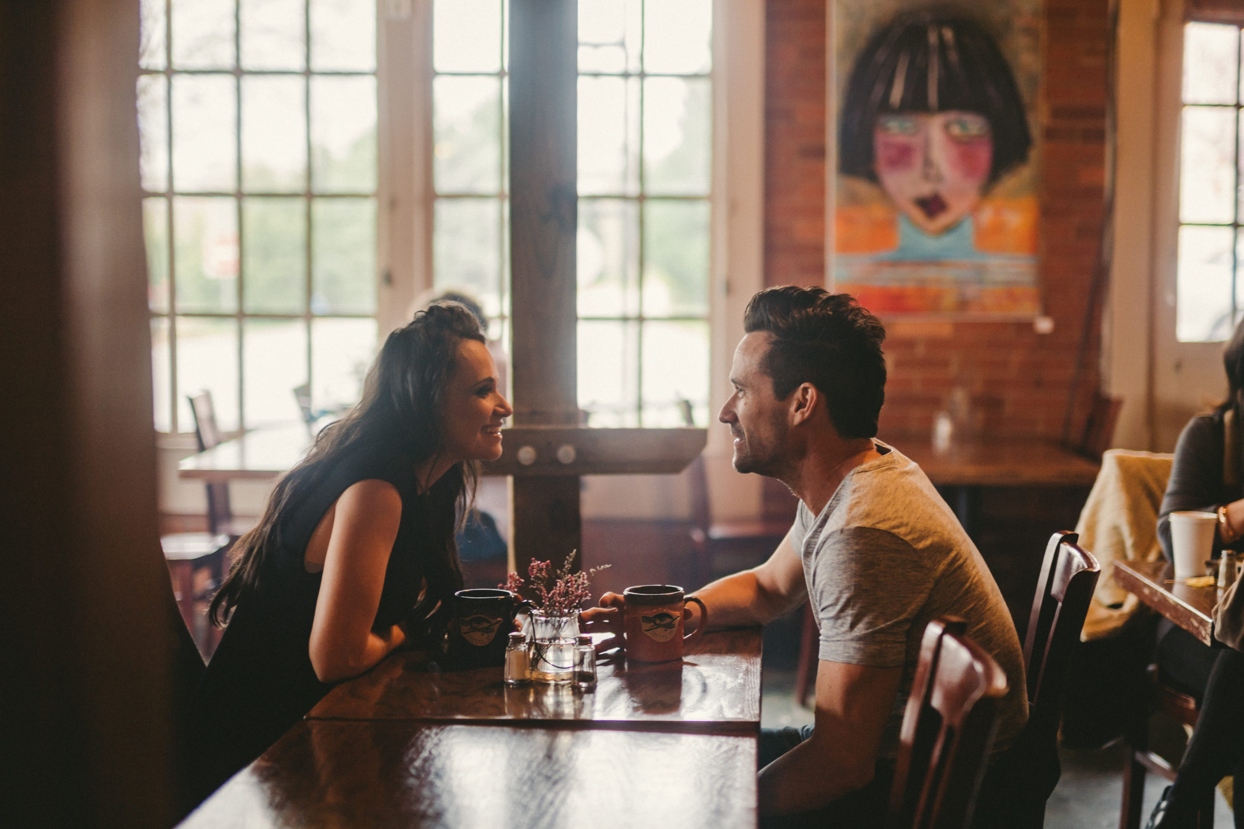 JSM Man and woman looking at each other over a table in a restaurant