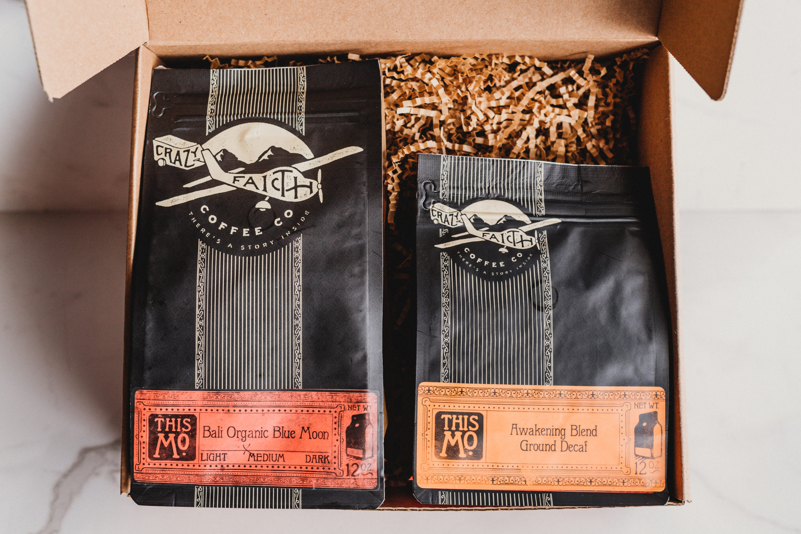 JSM Packages of Bali Organic Blue Moon and Awakening Blend Groud Decaf coffee beans in a box
