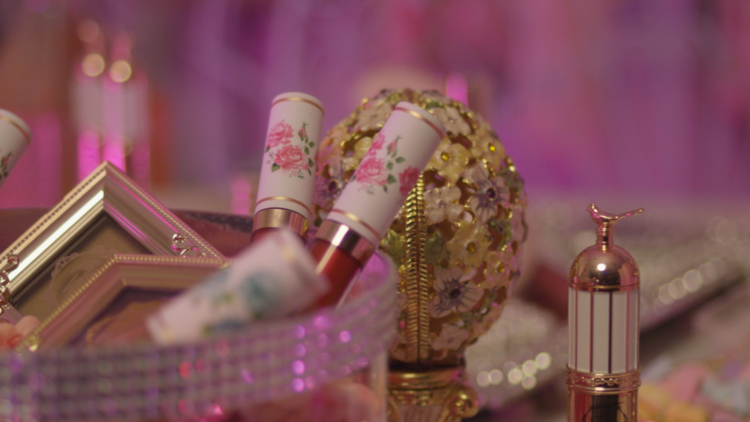 Video Production with Pretty Vulgar-Closeup of various makeup products. One is shaped like an egg with flower patterns.