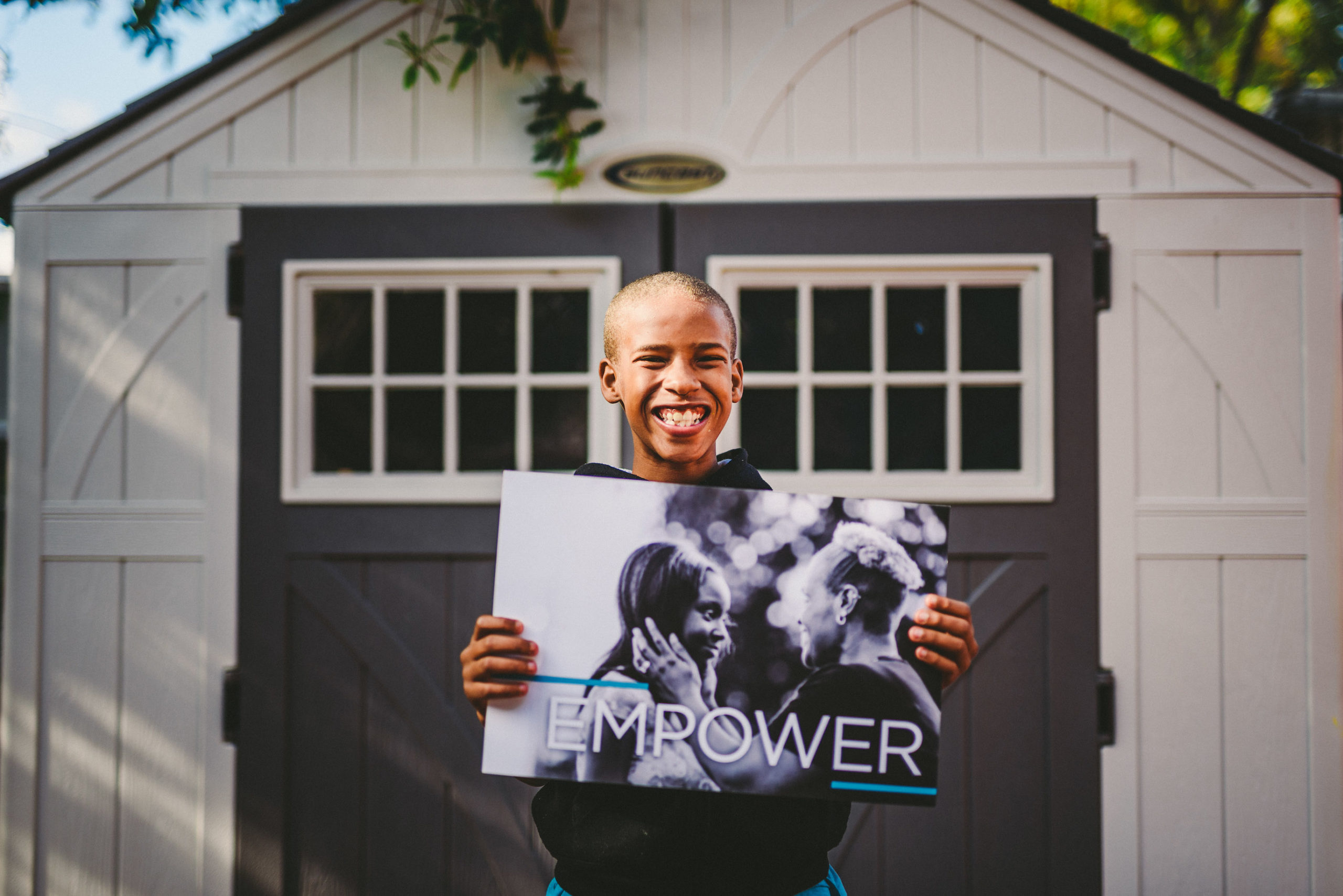 Marketing for nonprofit organizations Handy Nonprofit African American holding a black and white poster with two people with the word Empower