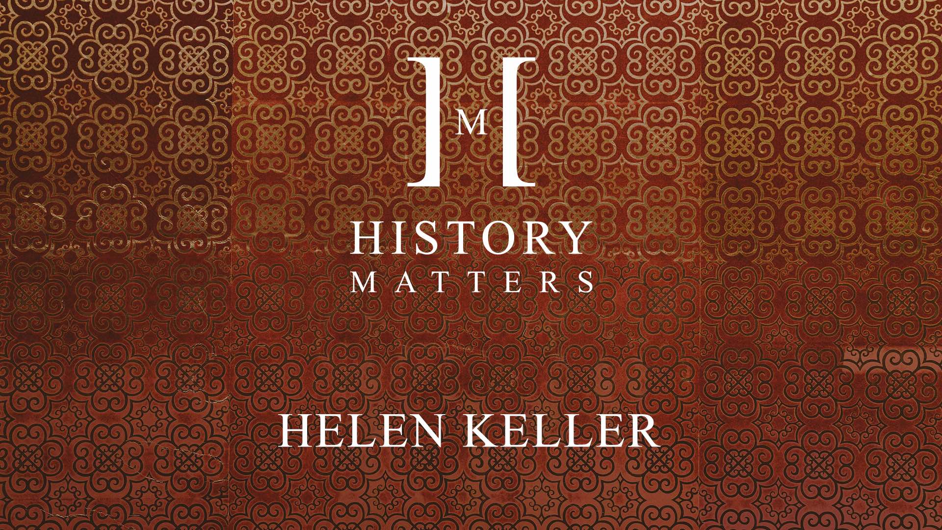White HM Helen Keller logo with background of red patterned tiles