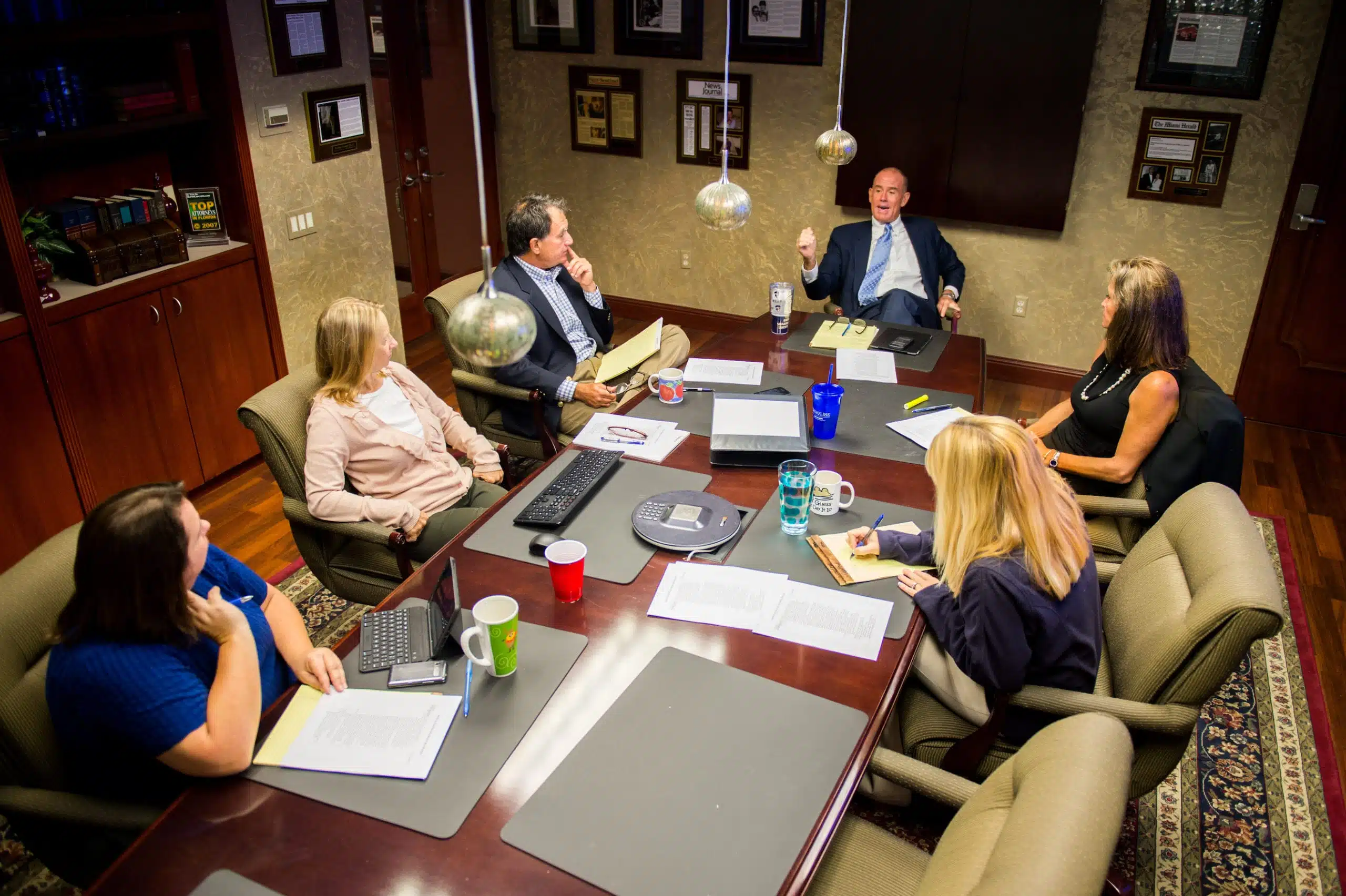 Overhead view of attorneys having a discussion at a table in a meeting room