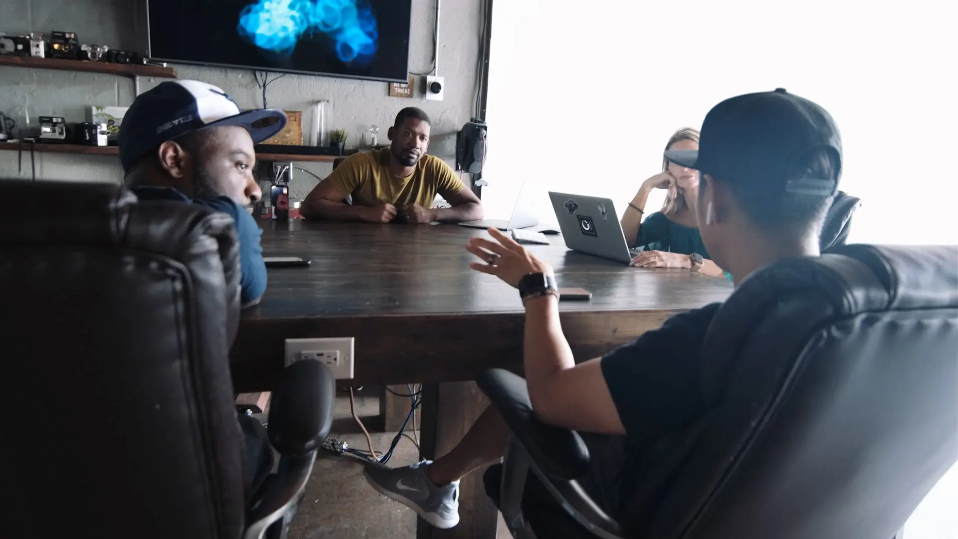 cis-post-brand-building-with-video-marketing3 Joshua and other staff members having a discussion in conference room.