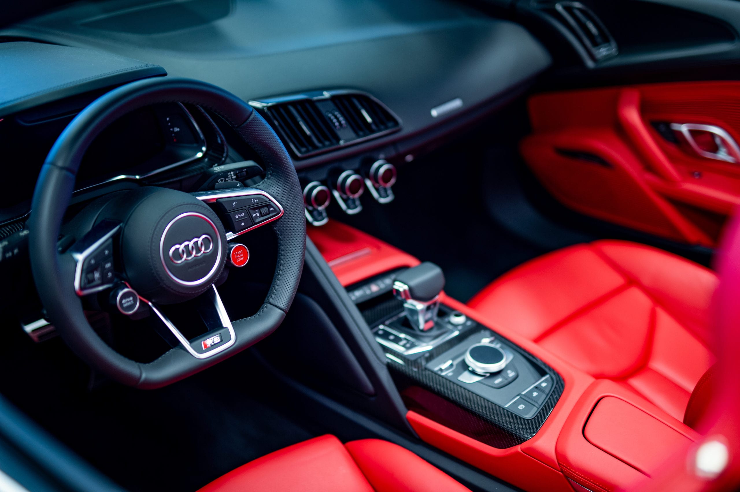 Car Offer Interior view of a luxury Audi car with red leather seats