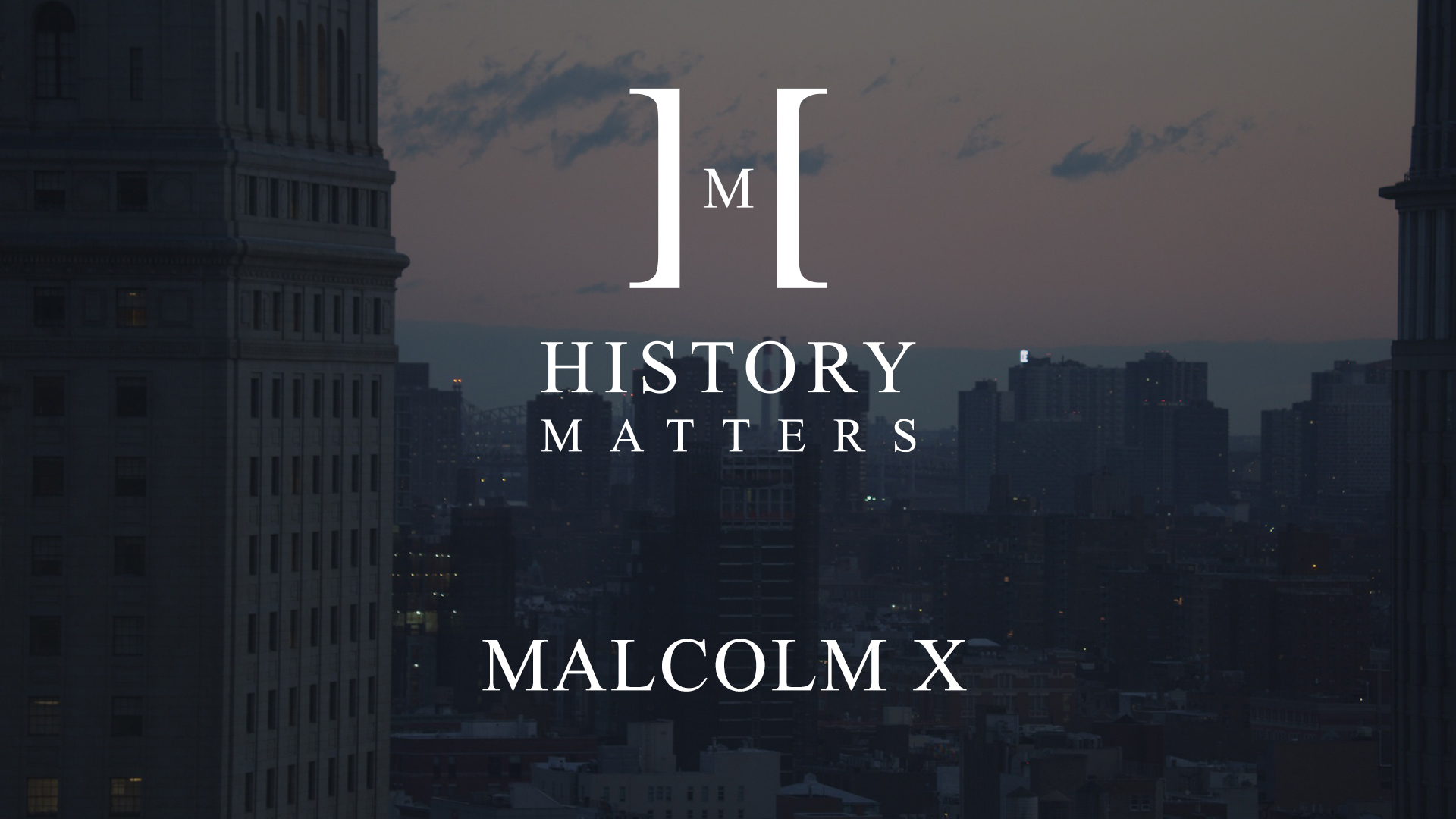 IU C&I Studios Page White HM Malcolm X logo with dimmed background showing an aerial view of a city at dusk