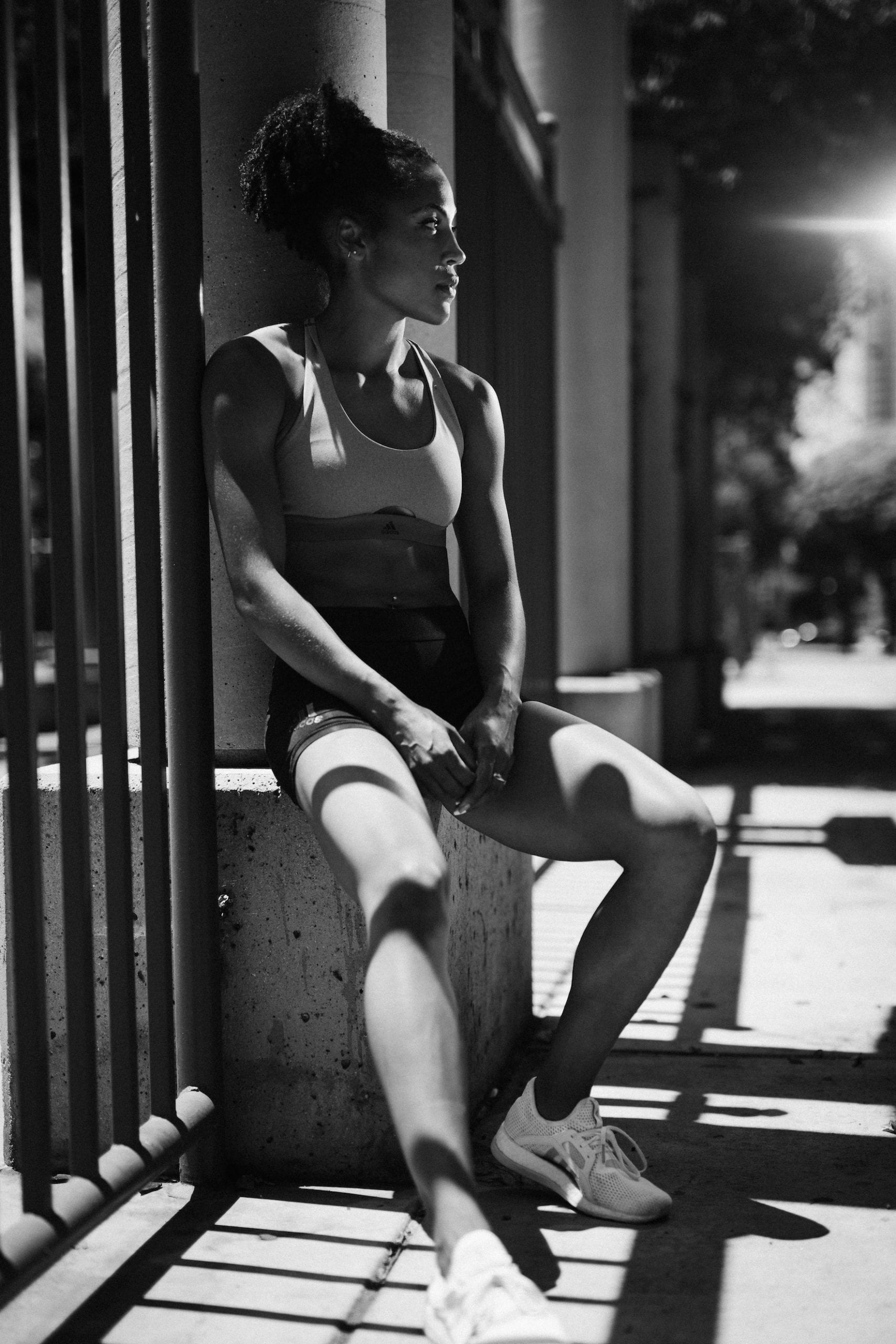 IU Karelle Edwards Black and white sitting on a concrete block by a gate