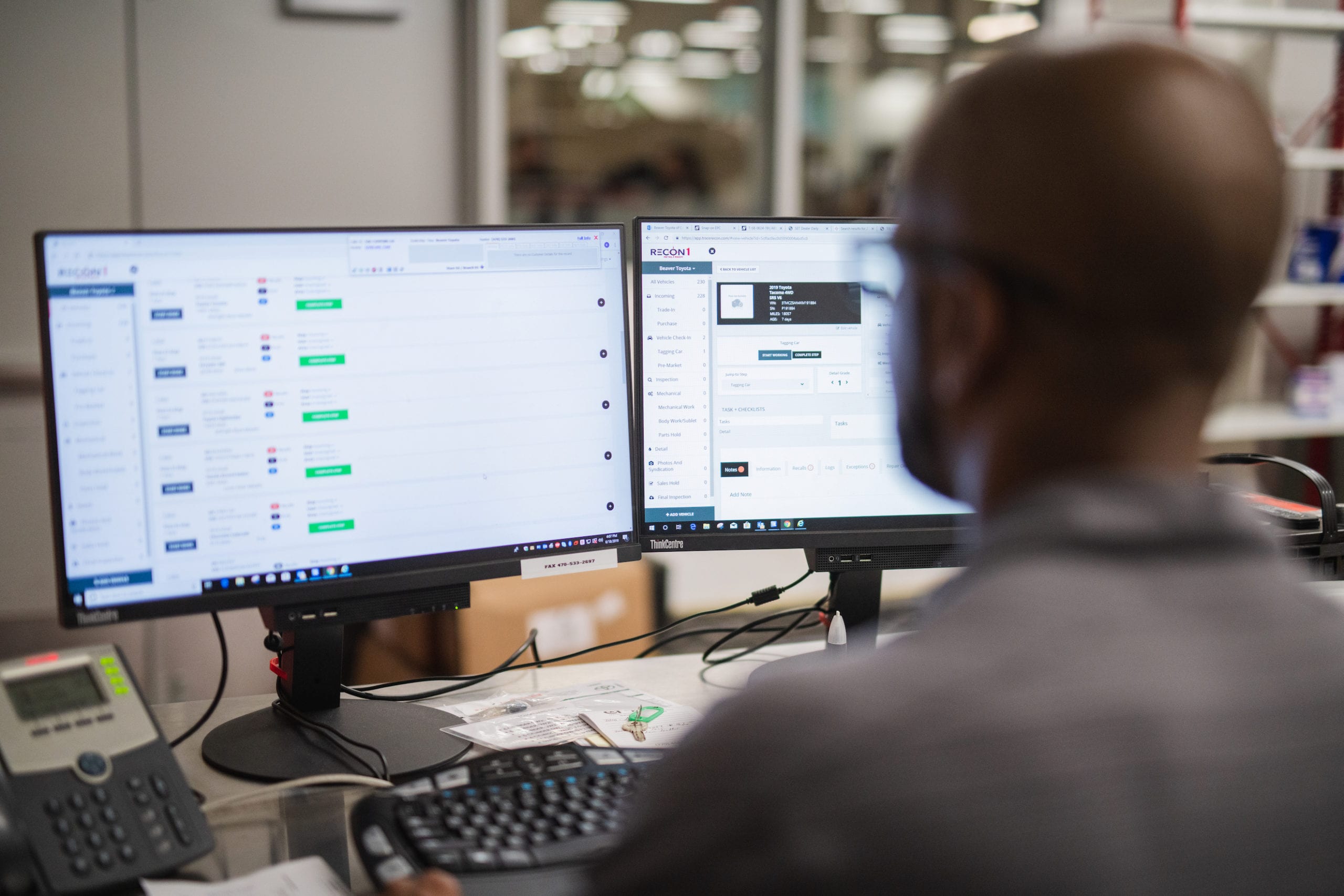 View from behind of an African American man working at a computer