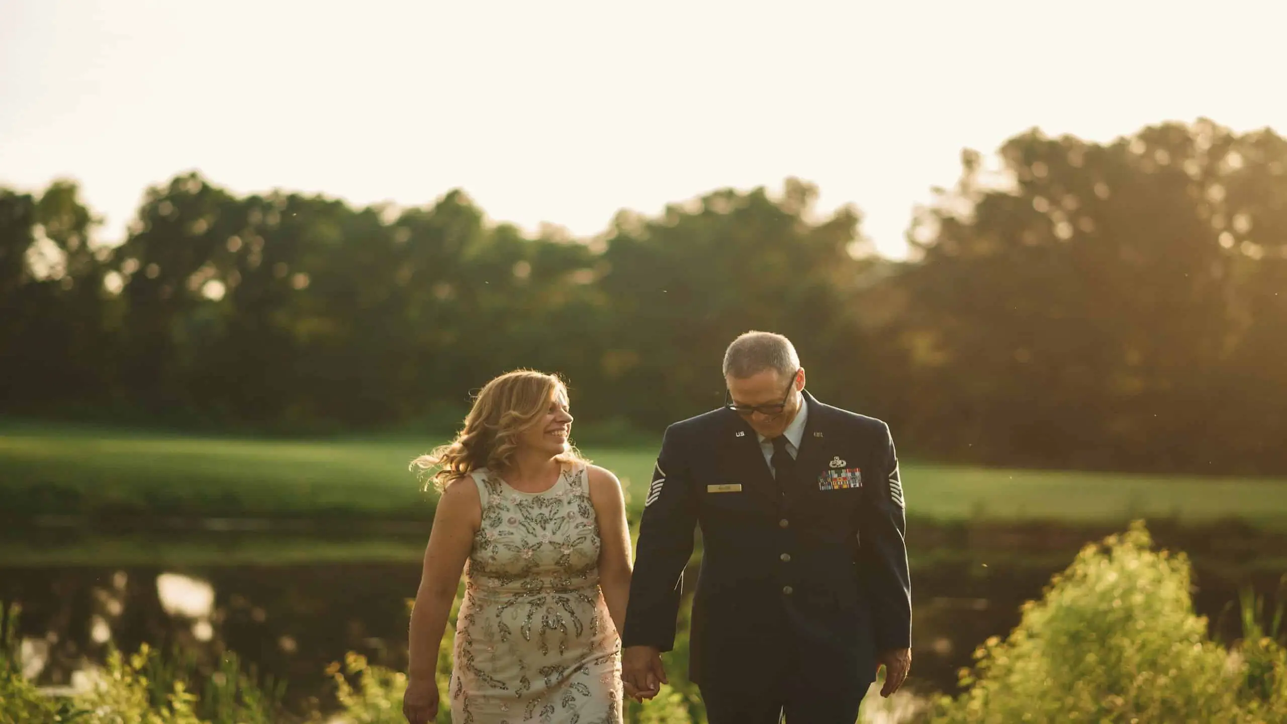 cis-post-3-secrets-to-great-storytelling-videos2 Woman smiling at man wearing a military uniform while they are both walking in a field