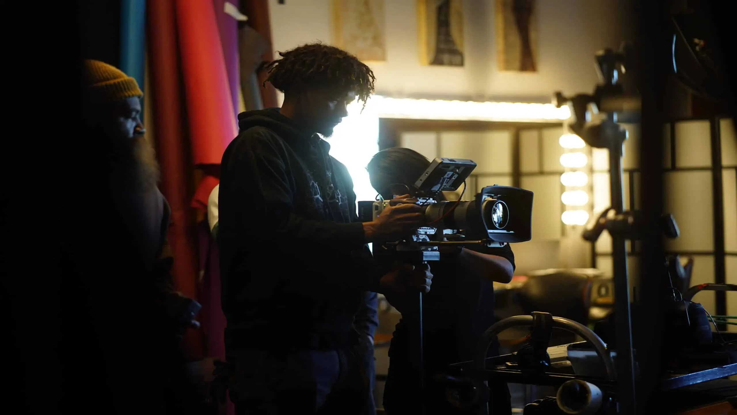 cis-post-why-invest-in-video-marketing7 Side profile of crew member using a video camera with Brandon behind him