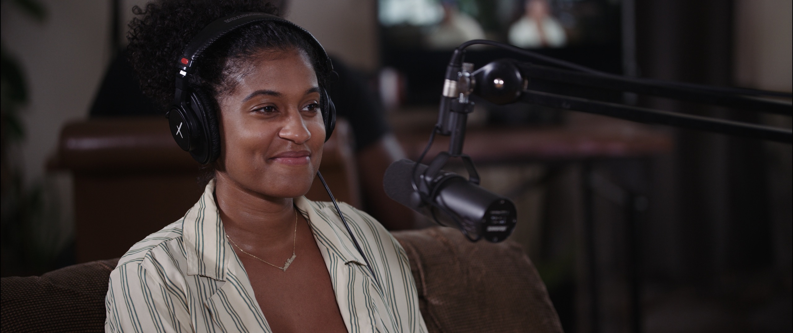 Uncreative Radio with Alexis Nichole Smith smiling by a microphone wearing headphones