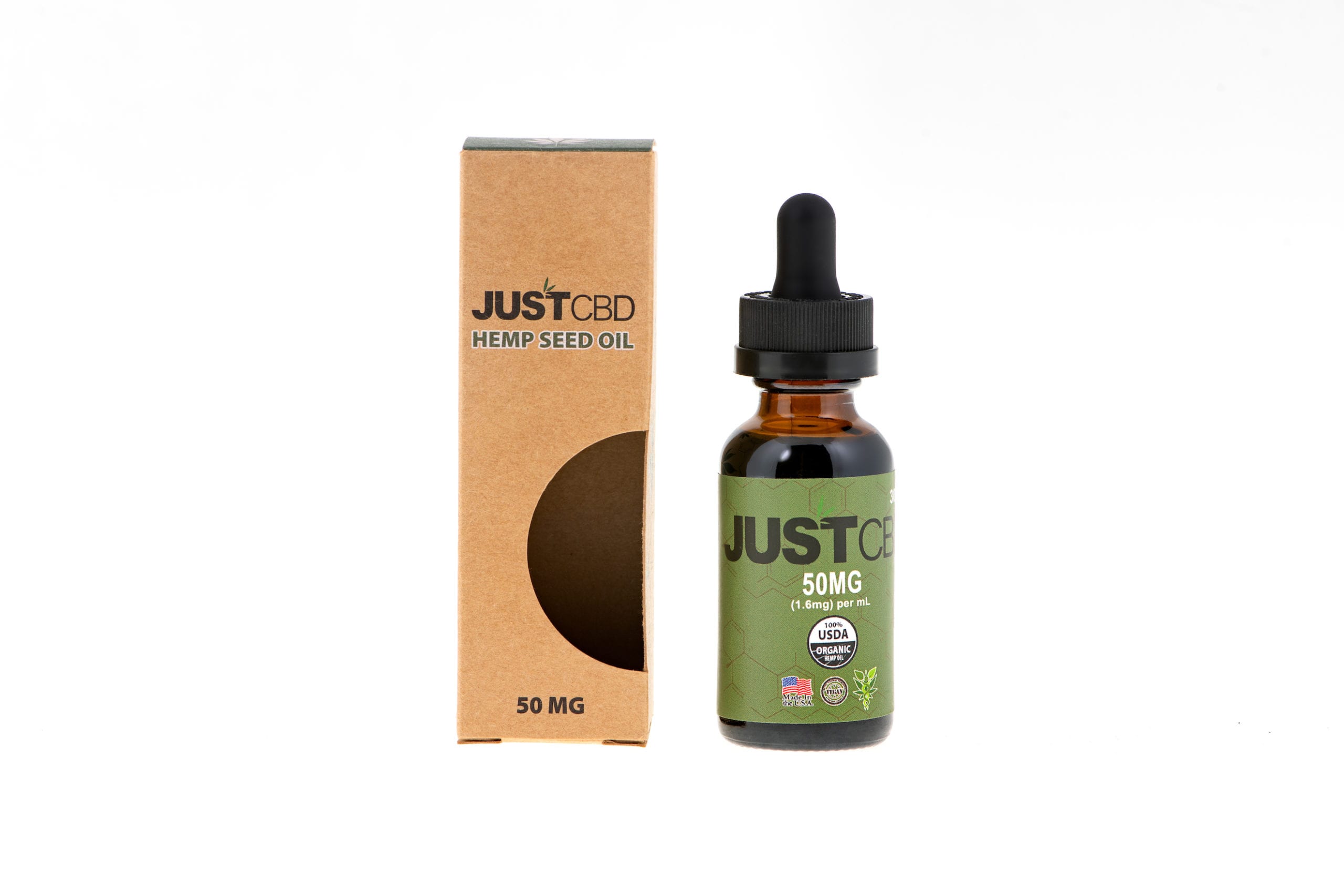 JustCBD Product Photography and Just CBD Products Closeup of JUST CBD Hemp Seed Oil drops bottle with package