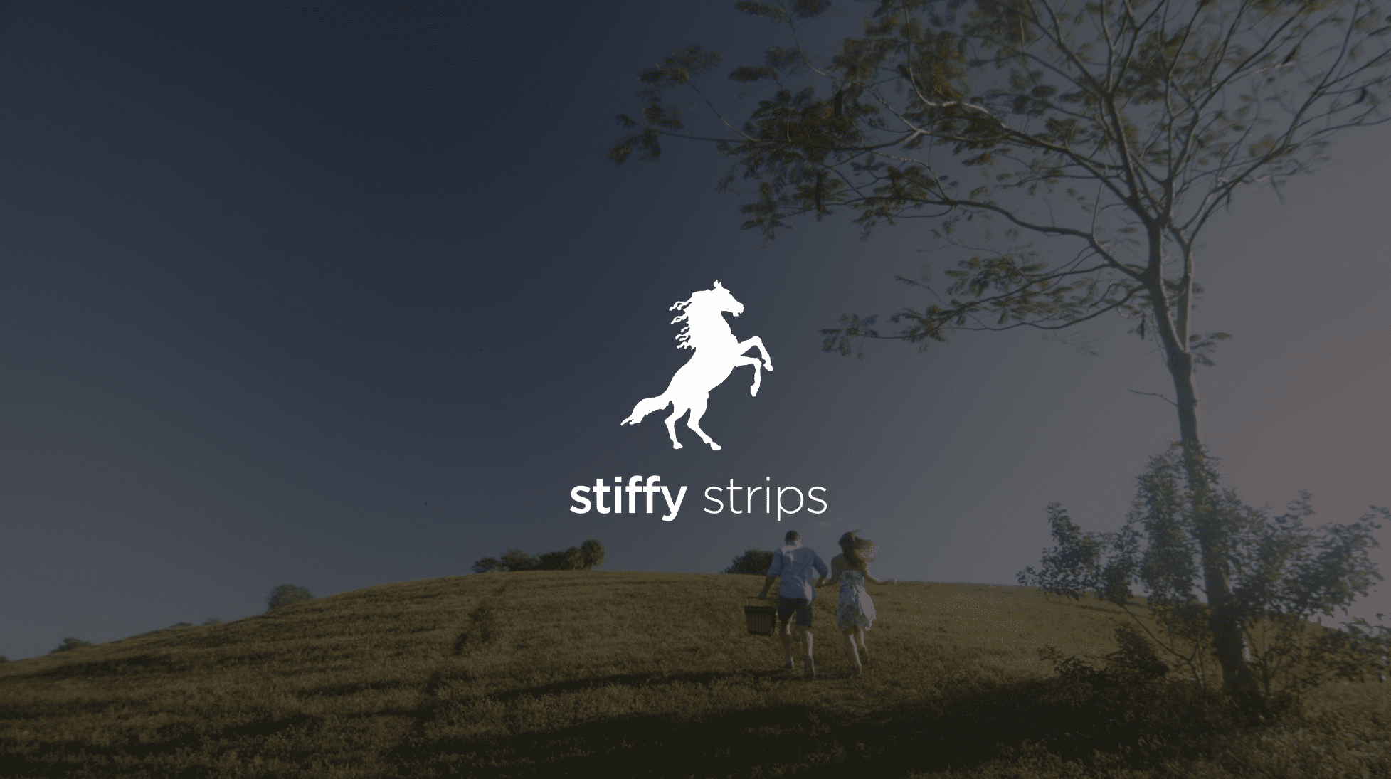 IU C&I Studios Page White Stiffy Strips logo with graphic of rearing Stallion with background of man and woman walking up a hill with the man carrying a picnic basket