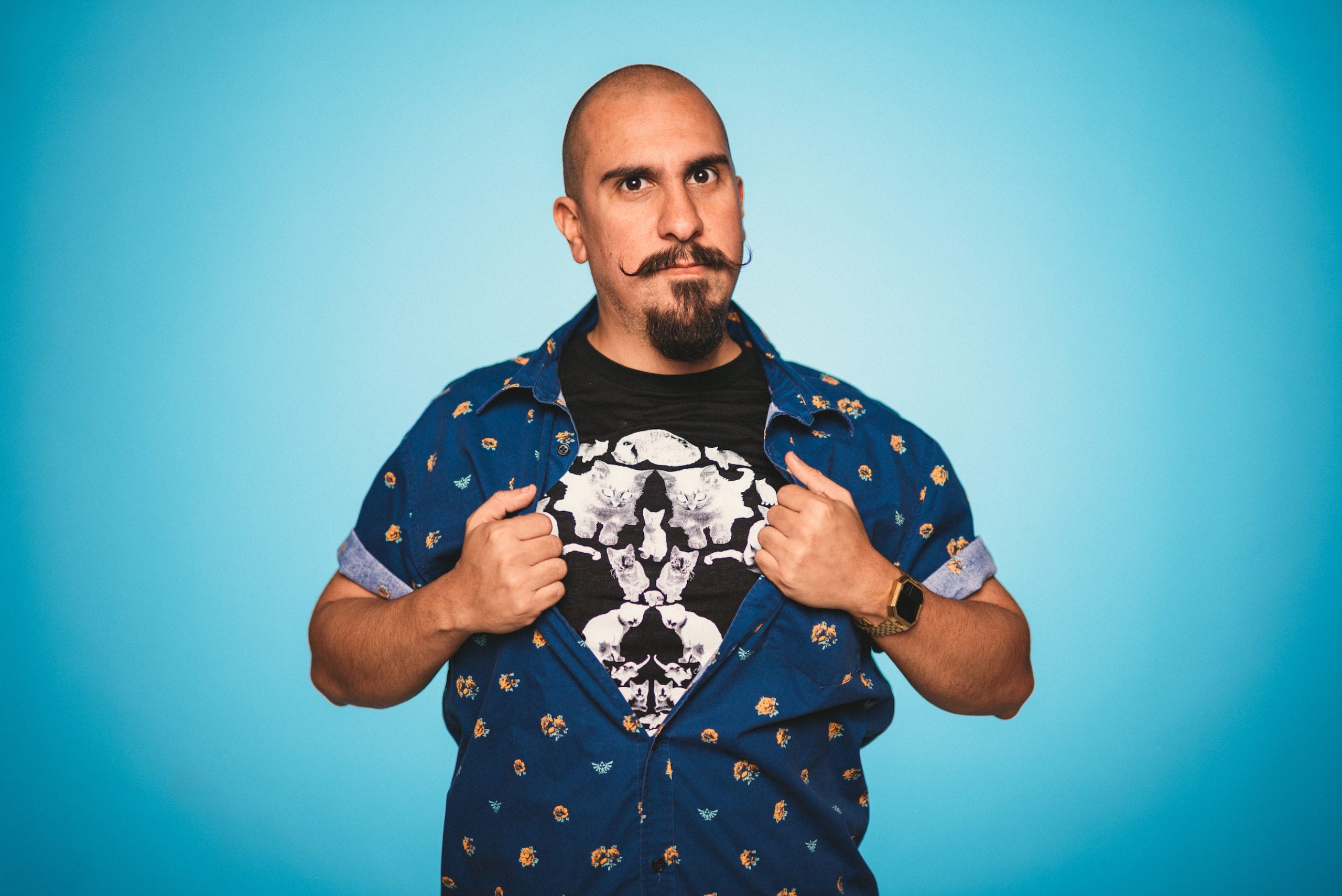 IU C&I Studios Portfolio Heart Piece Media Day Bald man with a moustache posing for the camera with a light blue background