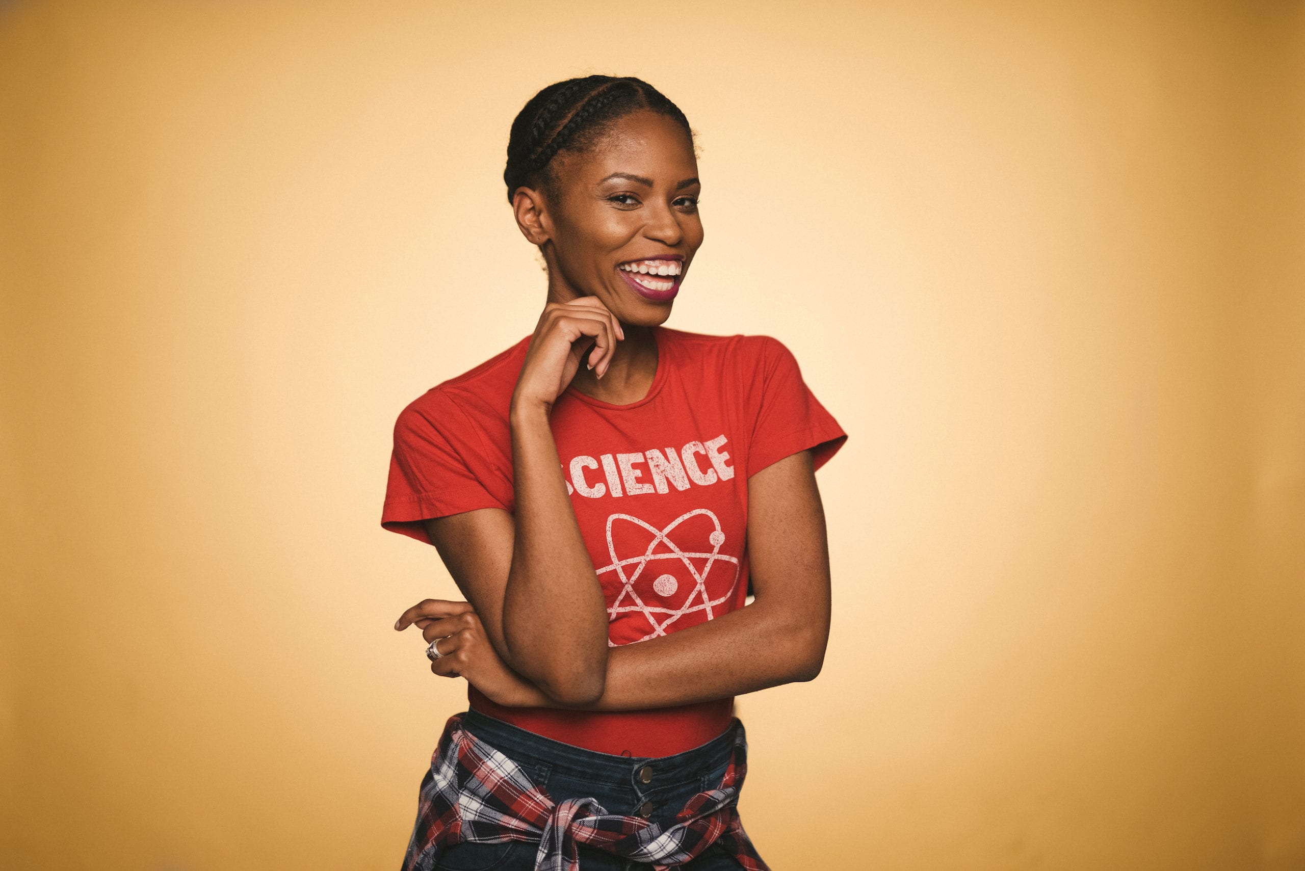 IU C&I Studios Portfolio Heart Piece Media Day African American woman wearing a red Science t shirt with graphic of atom smiling and posing for the camera
