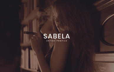 Sabela Artist Profile With Sabela With Long Hair Holding A Cigar Posing For The Camera