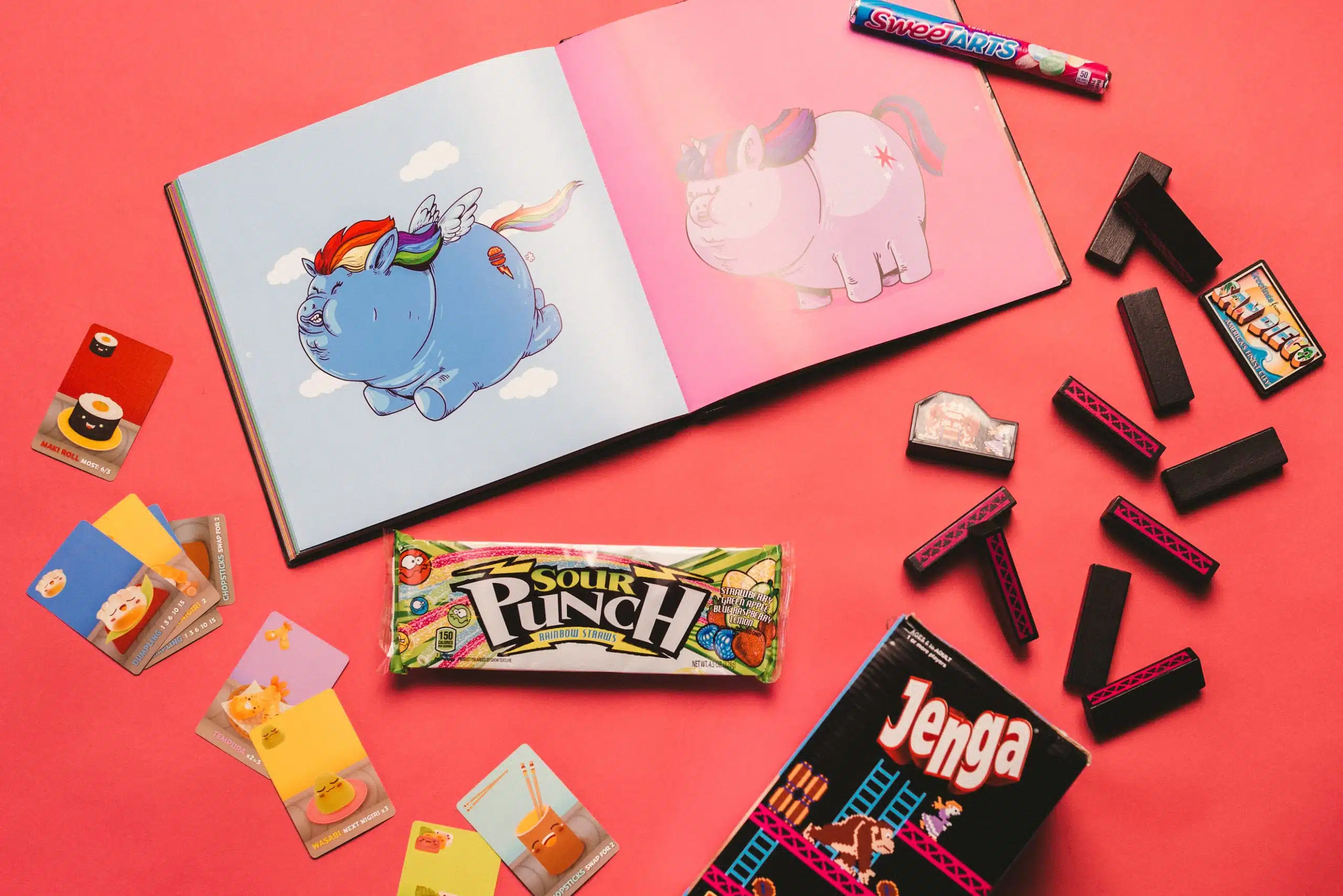 Heart Piece Plus 9 Candy, cards and game pieces on display by an open book showing cartoons