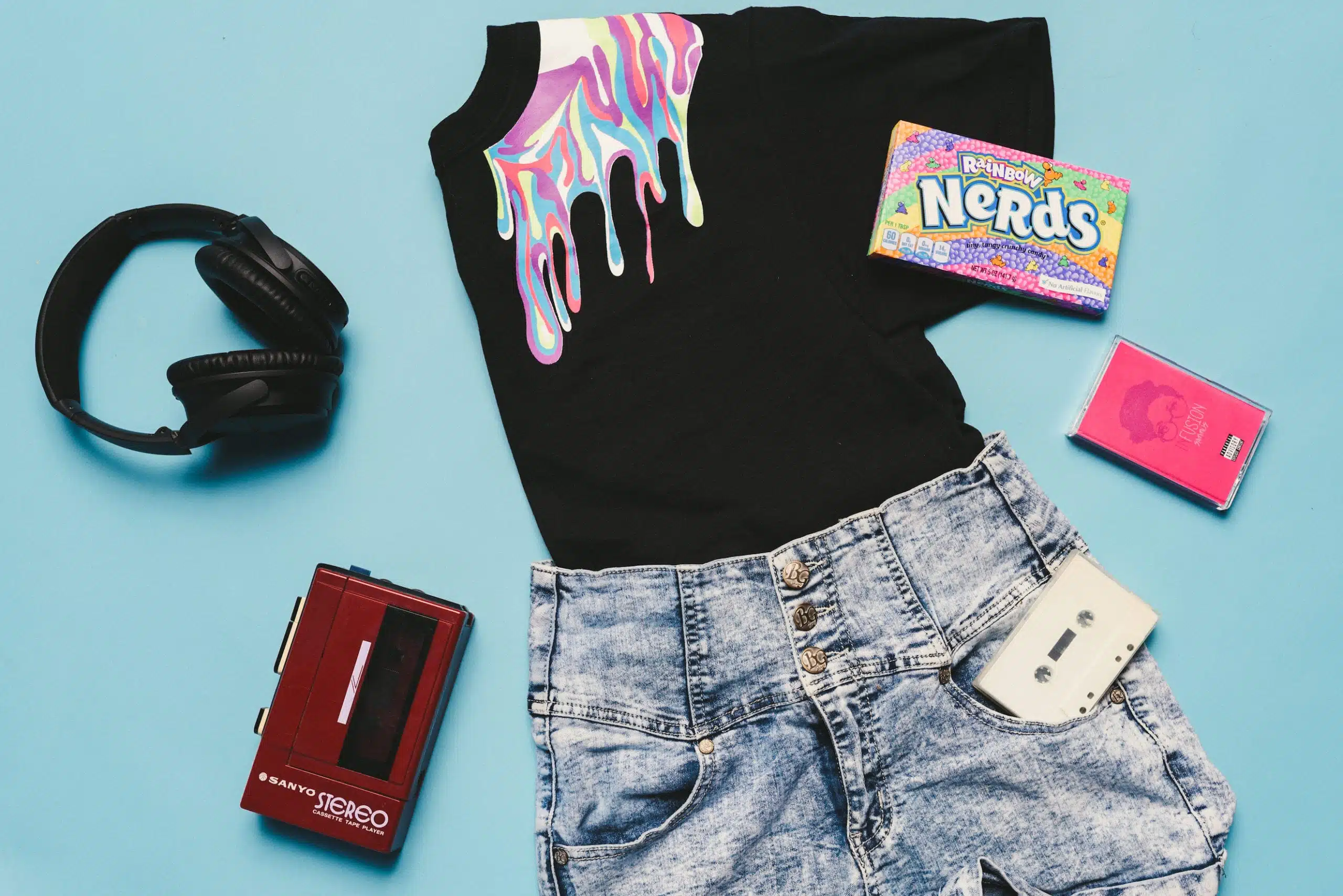 Heart Piece Plus 10 Black top, jeans, audio cassette, audio cassette player, box of Nerds candy and black headphones on display