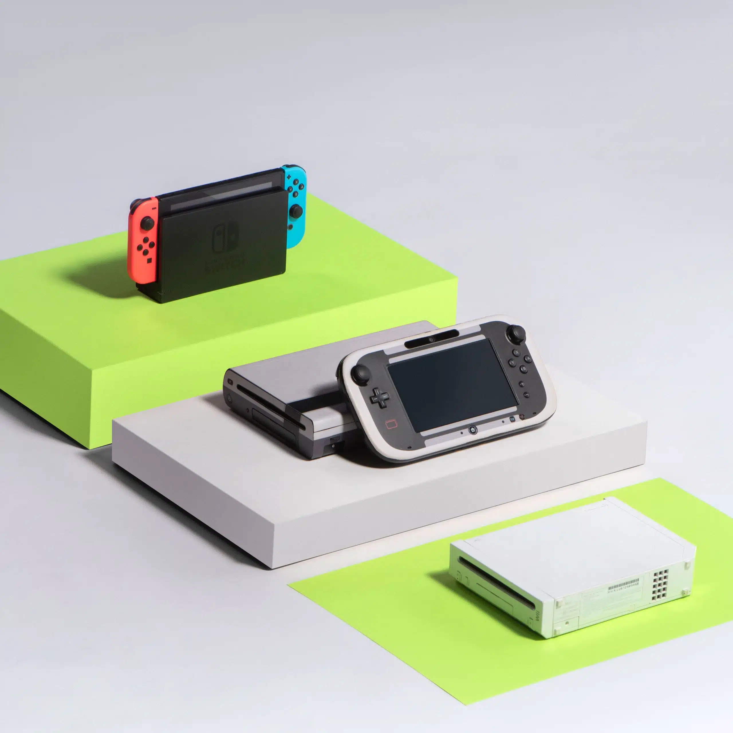Heart Piece Plus 13 Two hand held video game consoles as well as another gaming console on display