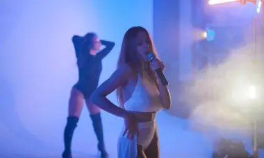 Sabela performing with another female performer behind her