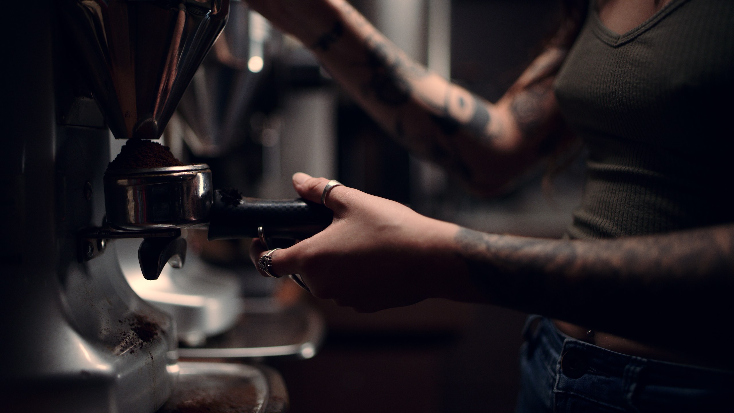Brew Barista Social Media Shoot Closeup of tattooed woman making a cappuccino