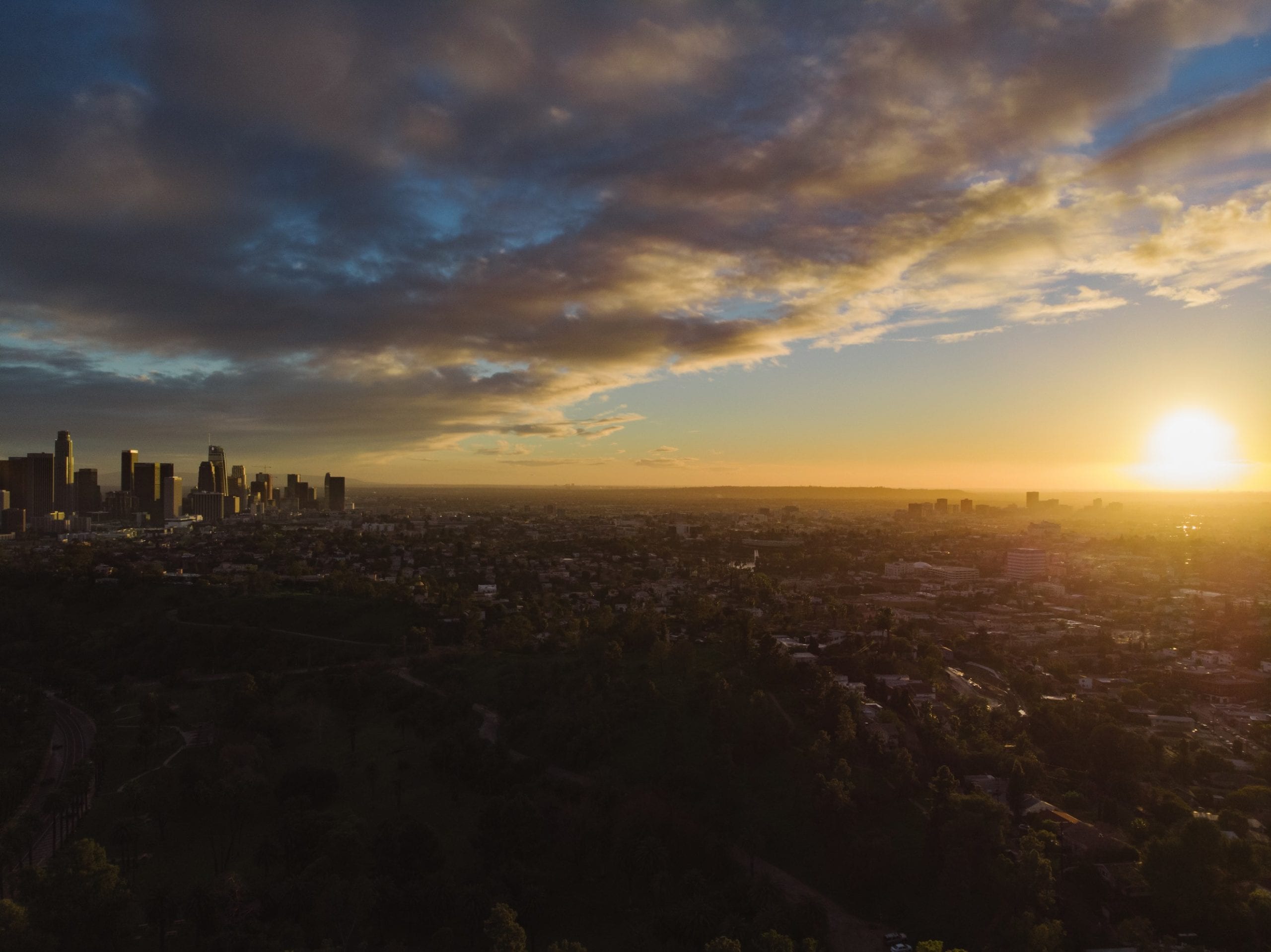 Audio Production Services by C&I Studios Aerial side view of cities with the sun in the distance