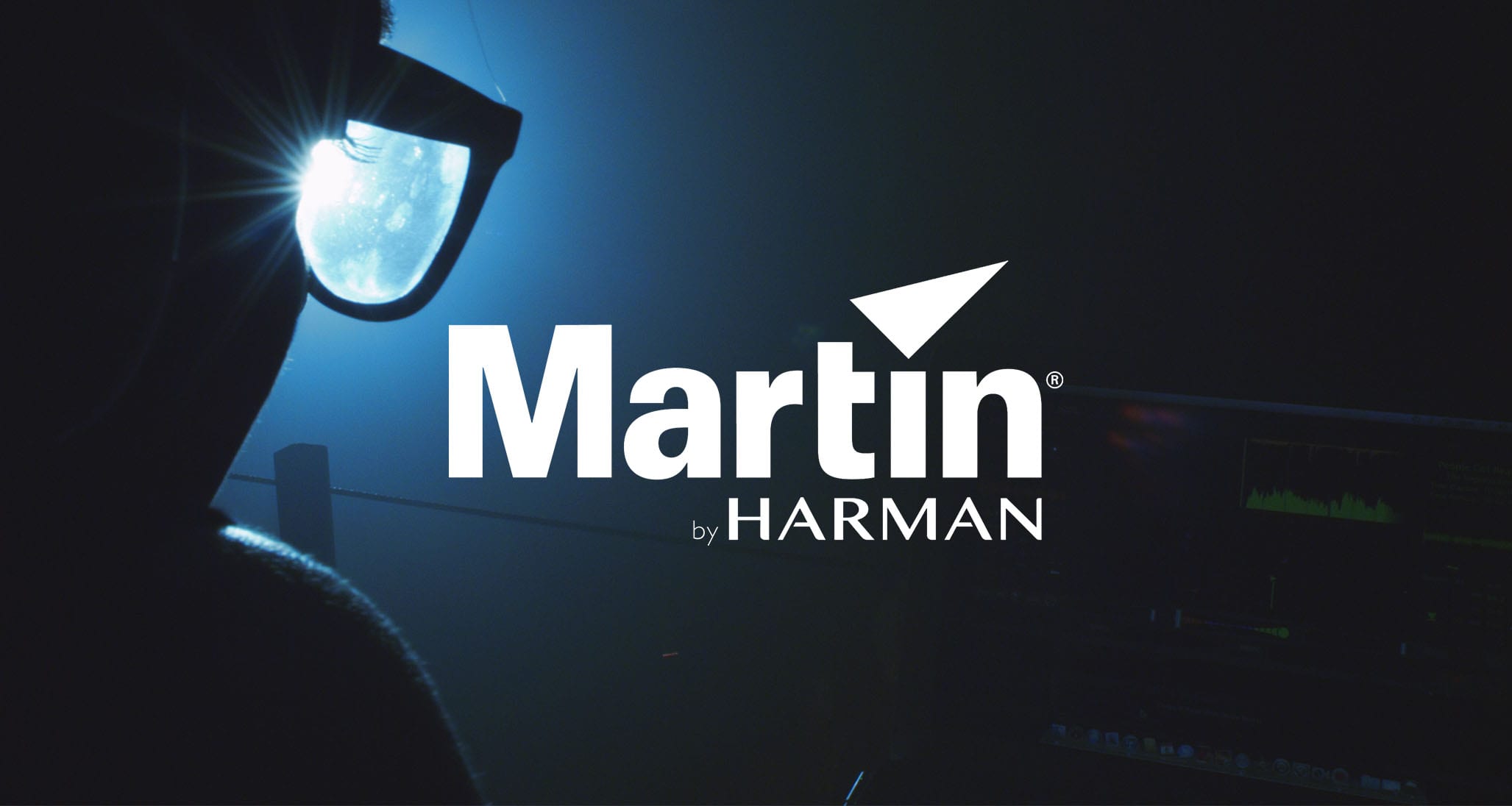 White Martin by Harman Lighting logo with background side profile looking through glasses of a person from behind