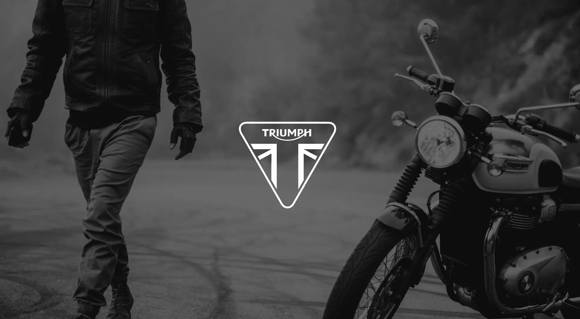 Keyword: Professional photography services .White Triumph logo against a black and white background of a man in motorcycle gear walking by the motorcycle