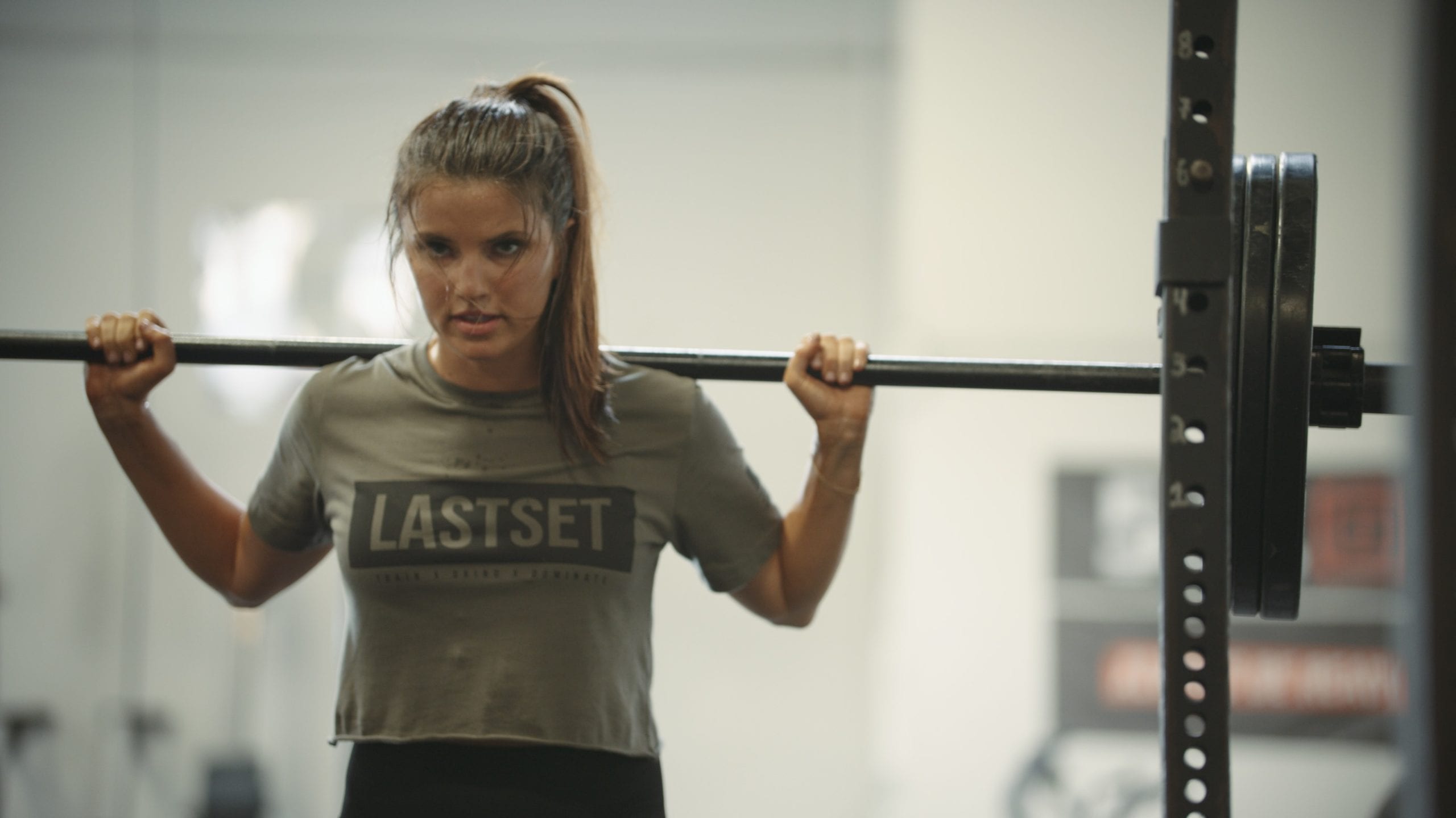 IU C&I Studios Portfolio LastSet Co Closeup of woman wearing a gray t shirt lifting weight