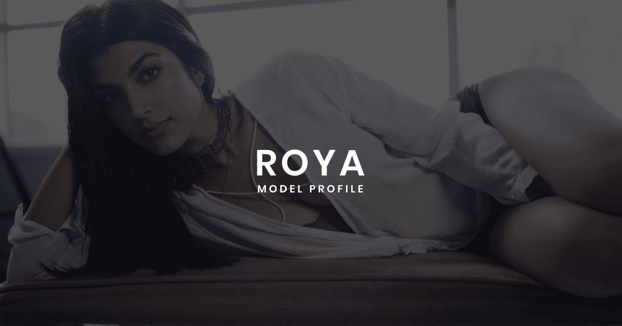 White Roya Zangoui Model Profile logo with woman with long hair laying on her side posing for camera in the background