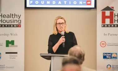 Woman speaking to audience at Healthy Housing Foundation event