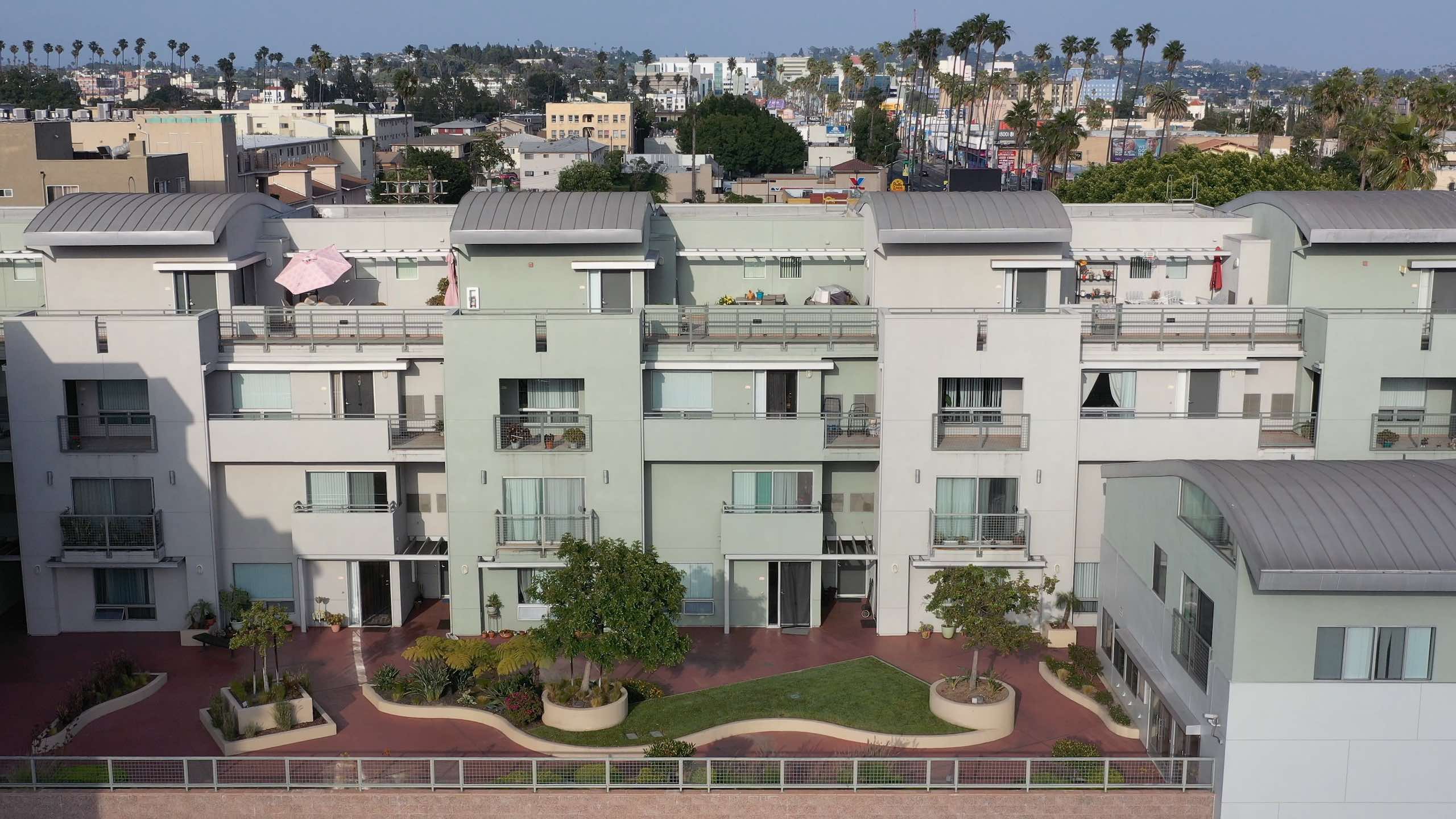 Hollywood Community Housing company profile with aerial view of housing in a city