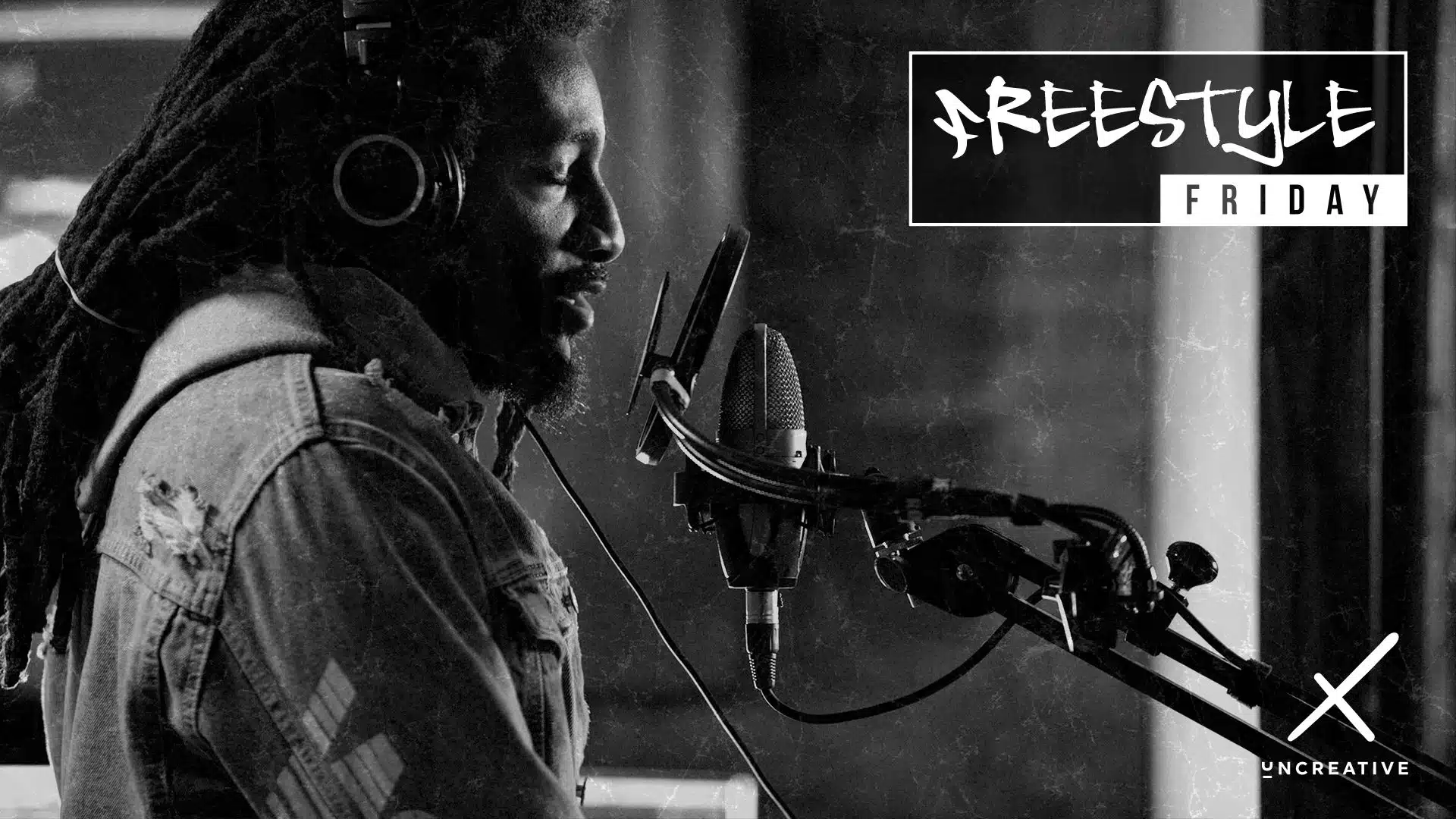 IU C&I Studios Page White Uncreative Freestyle Friday logo Featuring Heavy Game with black and white background side profile of him singing into a microphone with eyes closed wearing headphones