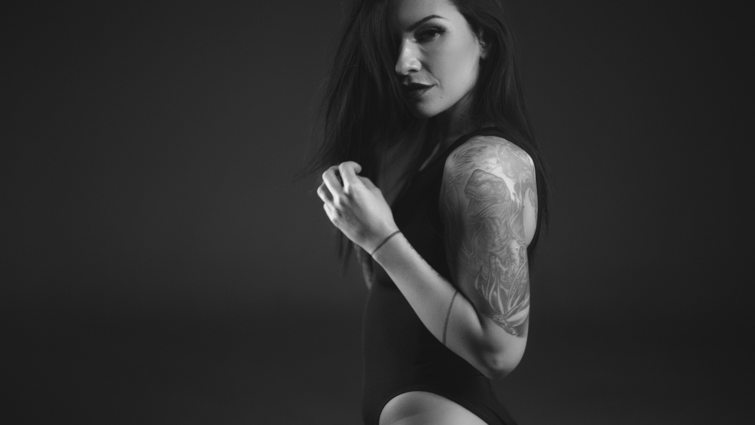 Crew Call The Tattoo Project C&I Studios Black and white side profile of a tattooed model with long hair wearing a bathing suit