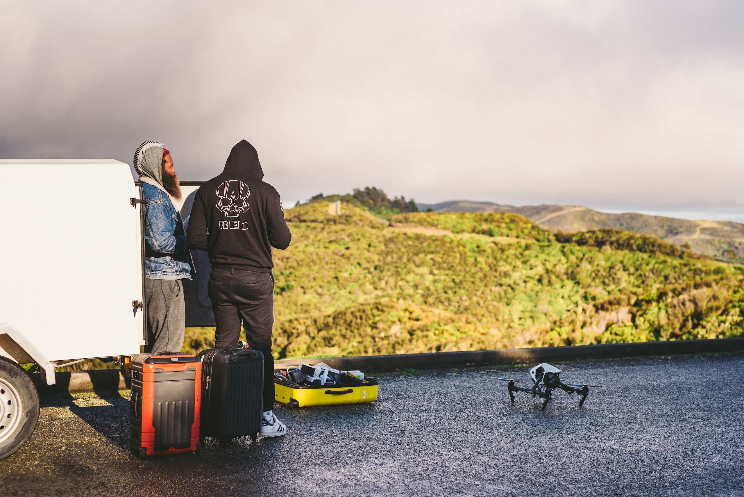 Drone Video and Drone Footage - Video and Film Production Services in New York City Two crew members by a white fan looking out over a valley with drone and equipment around them