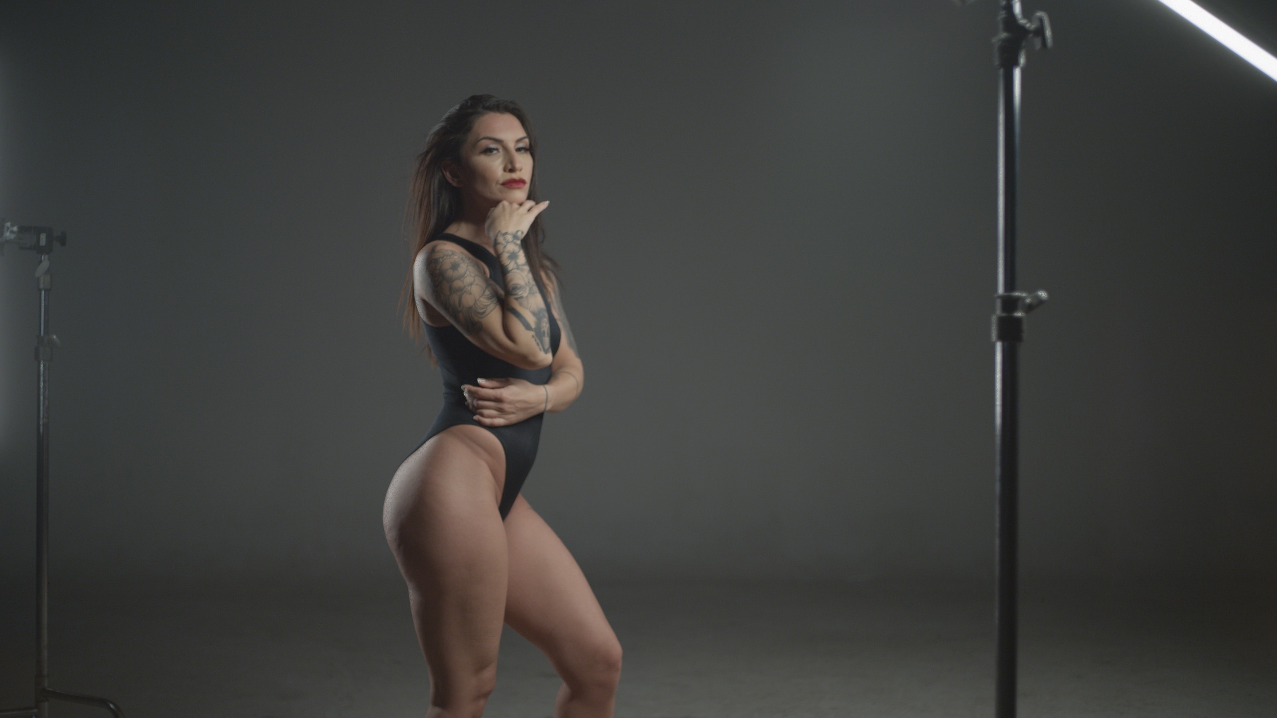 Puma Side profile of tattooed woman in black bathing suit