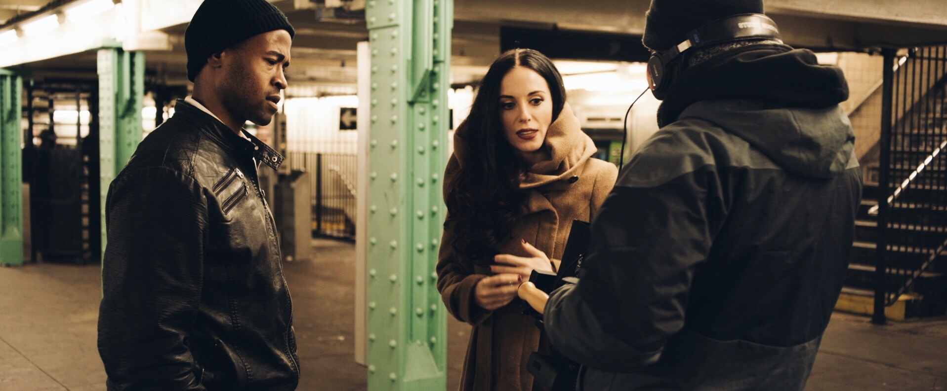 Feature film and televisions series production services by C&I Studios Crew member talking to man and woman in a subway