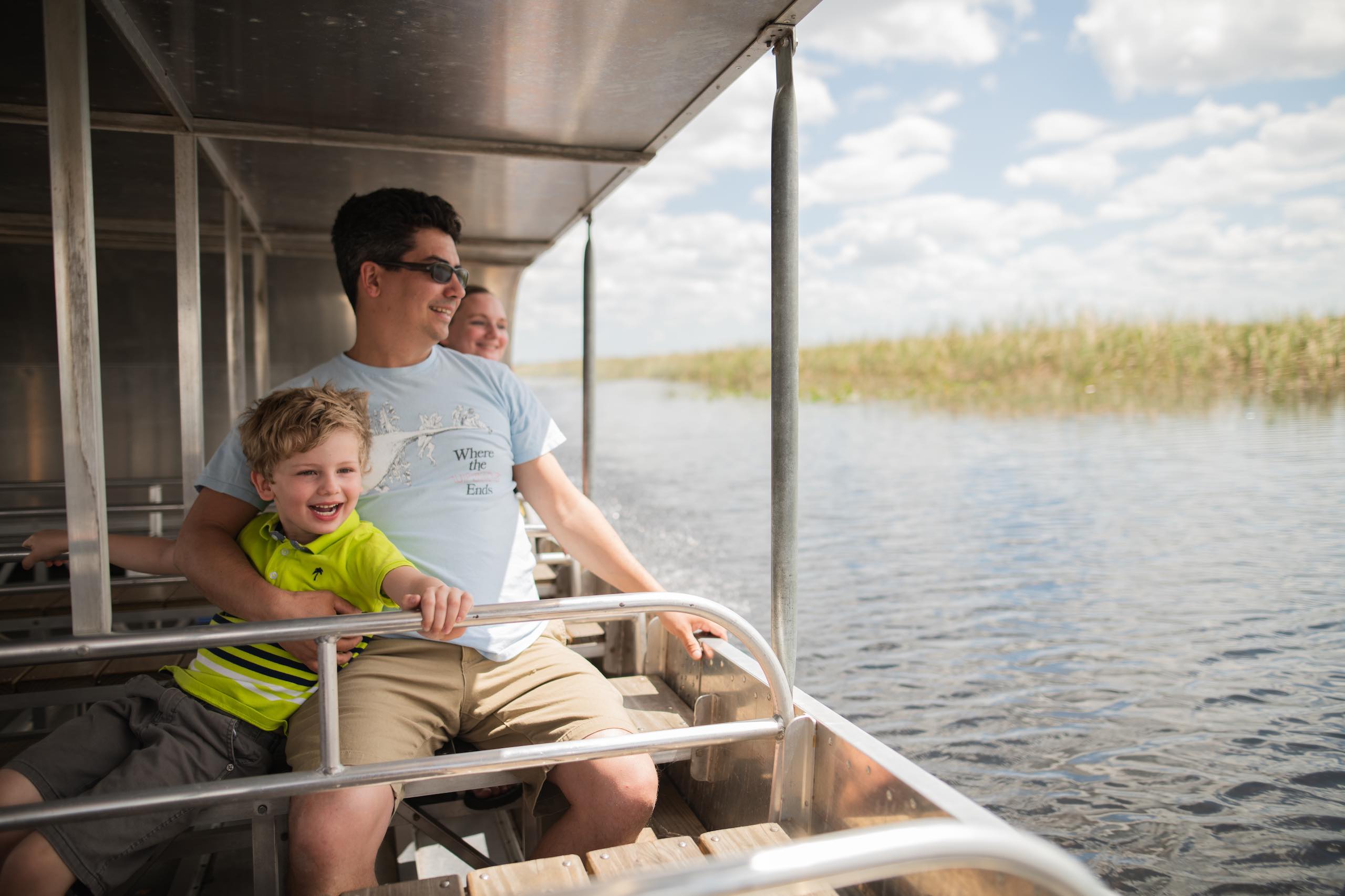 Everglades Holiday Park Father and son on an airboat looking out on the water
