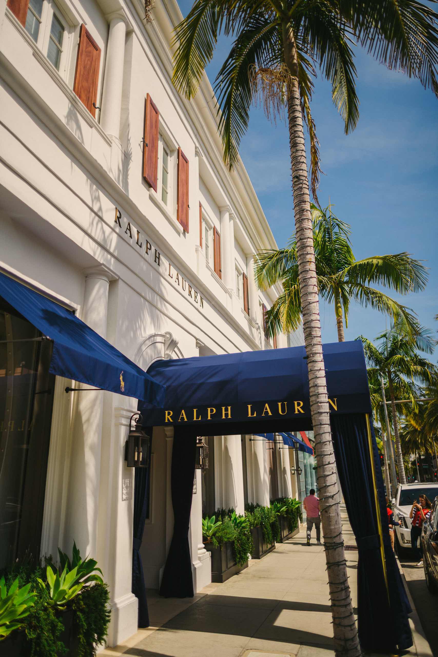 Peretti Italy branding and photography Closeup of Ralph Lauren storefront with palm tree near it