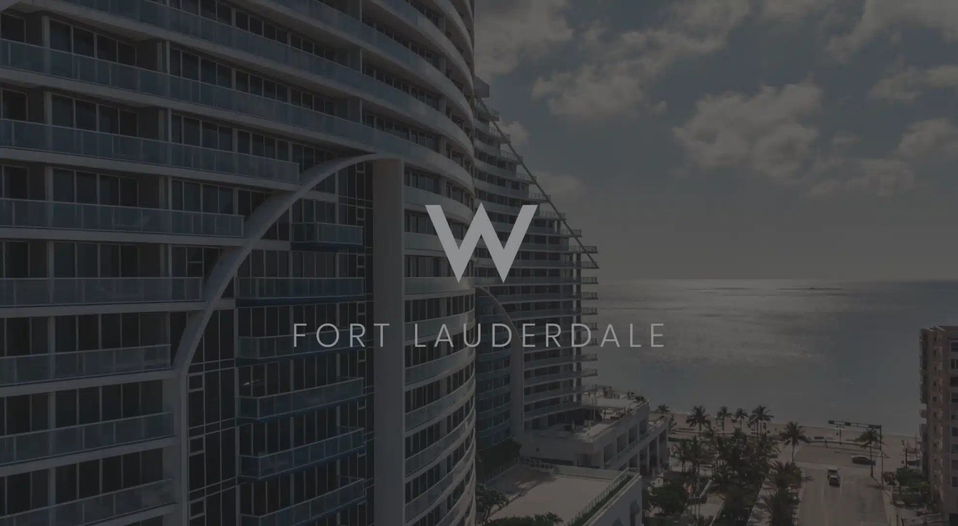 White West Fort Lauderdale Logo Social Media Marketing with dimmed background showing an apartment by a beach