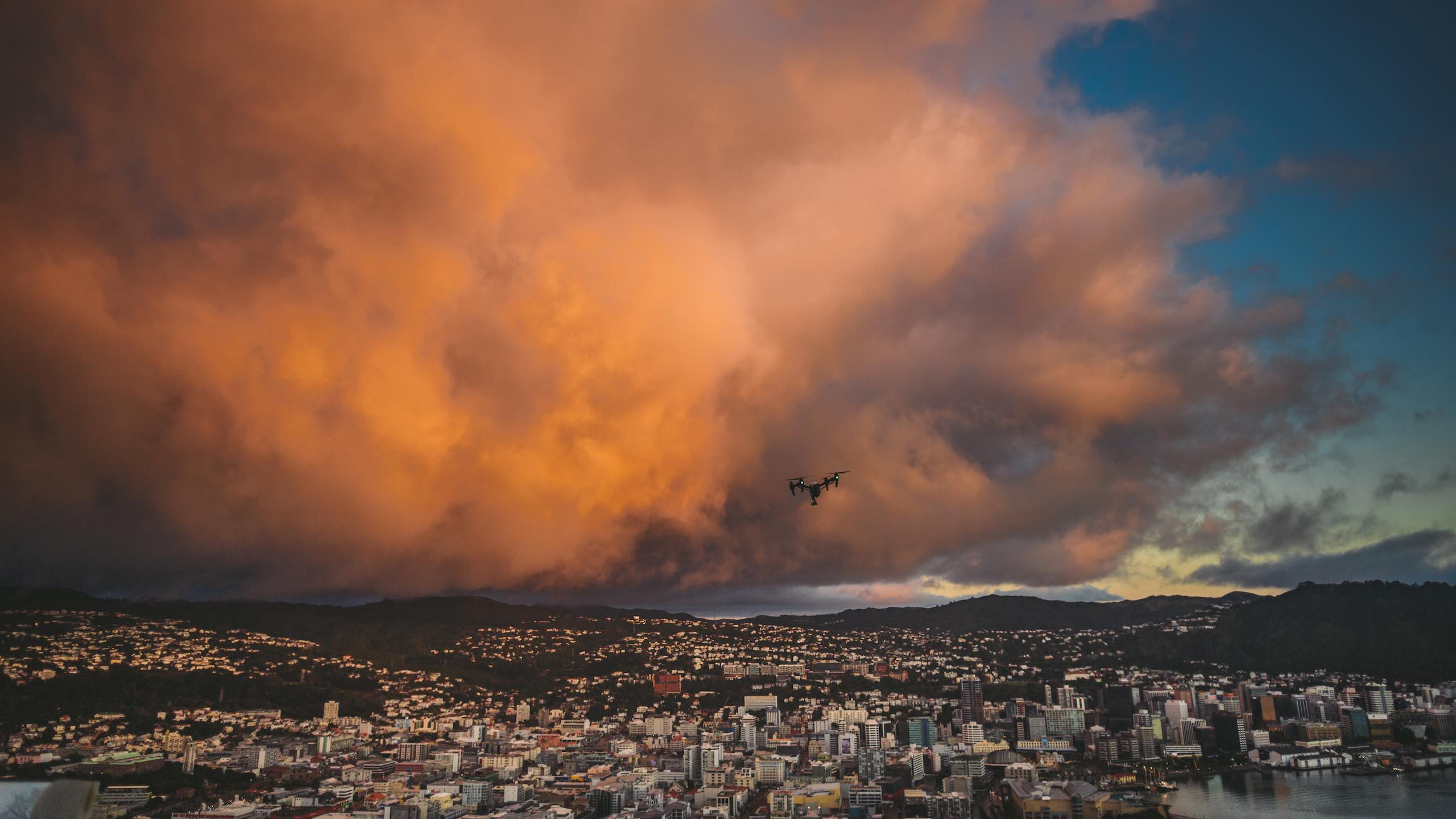 Magic Leap LA Video Production with view of a drone flying over a city with reddish orange cloud in the background