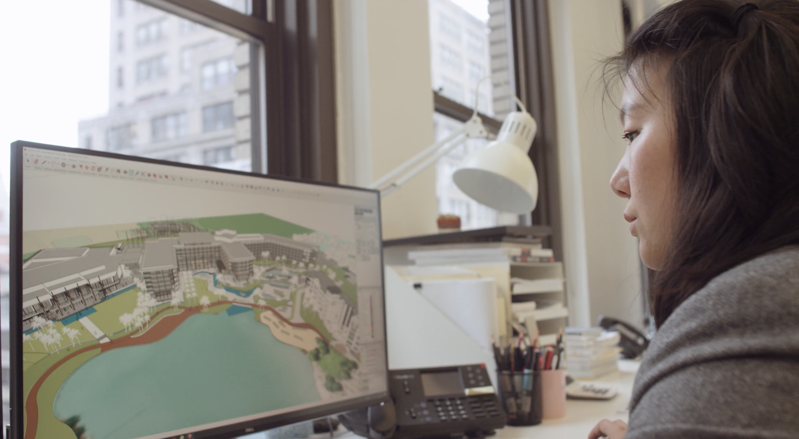 EDSA Design Studio NYC with side profile of woman working on desktop