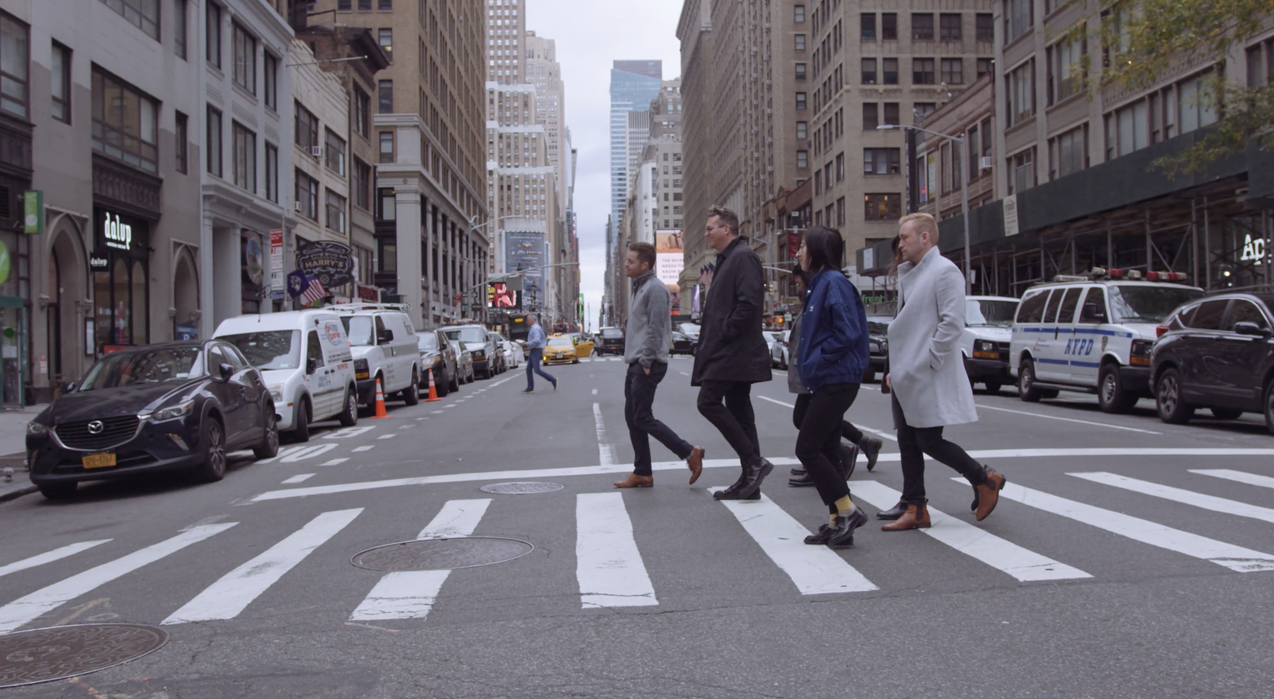 EDSA Design Studio NYC Three men and two women walking across a city street on a crosswalk