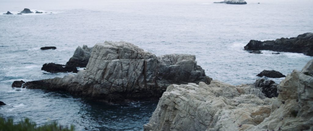 The Dailies Season 2 Episode 3 Komuso Big Sur with view of rocky outcroppings in the ocean by cliffs