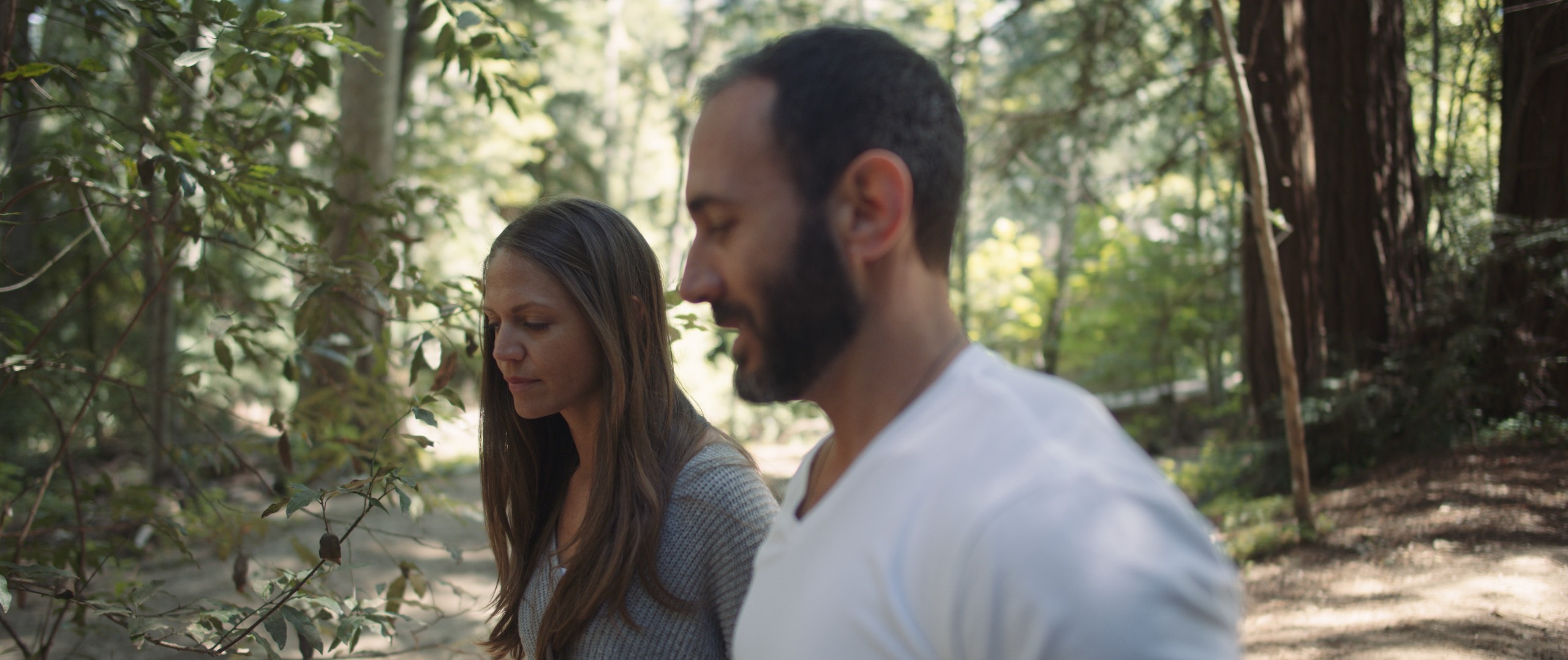 The Dailies Season 2 Episode 3 Komuso Big Sur with side profile of man and woman walking in the woods