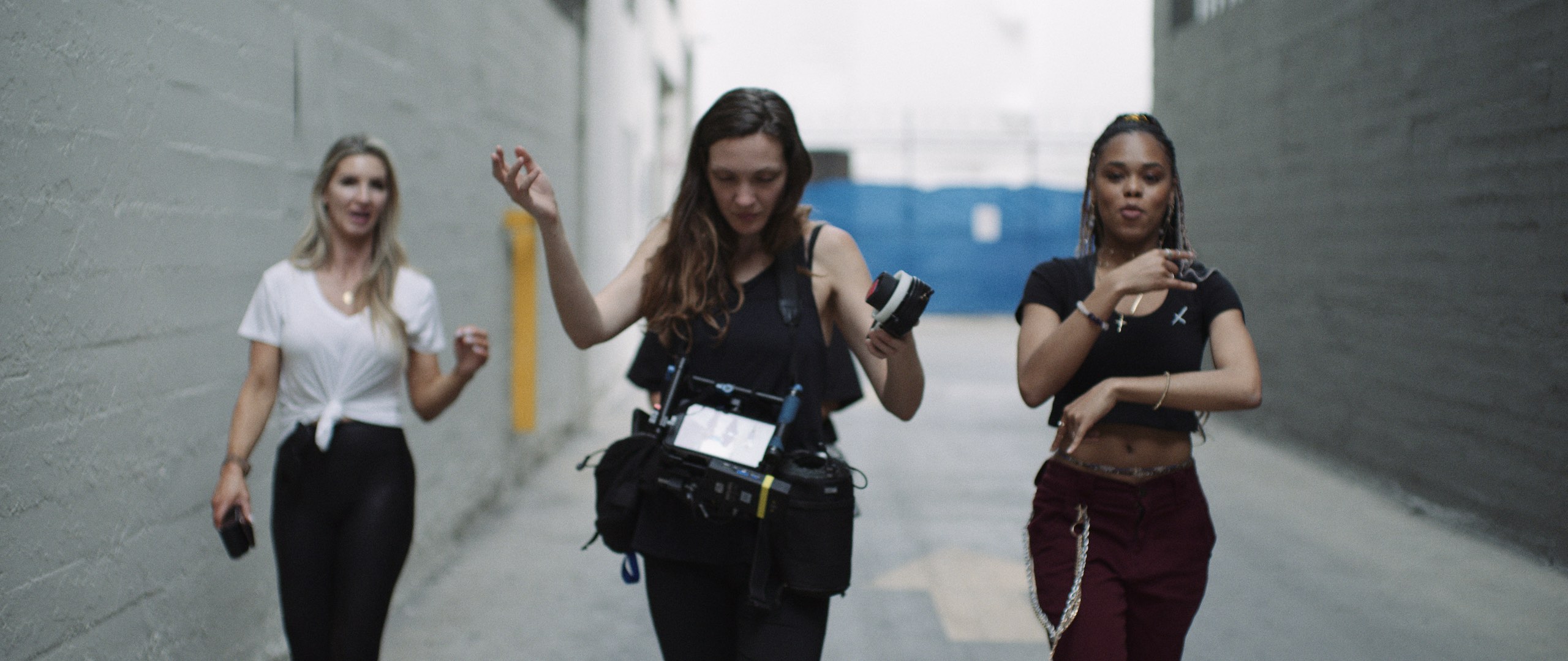 How to Create a Killer Tik Tok Campaign with two crew members and a female model walking down an alley