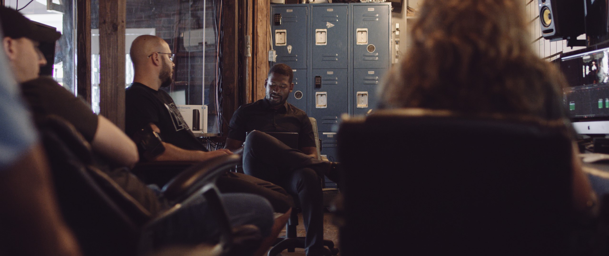 The Dailies Season 2 Episode 6, C&I Core Values with Joshua Miller talking with other crew members in a room all sitting in chairs