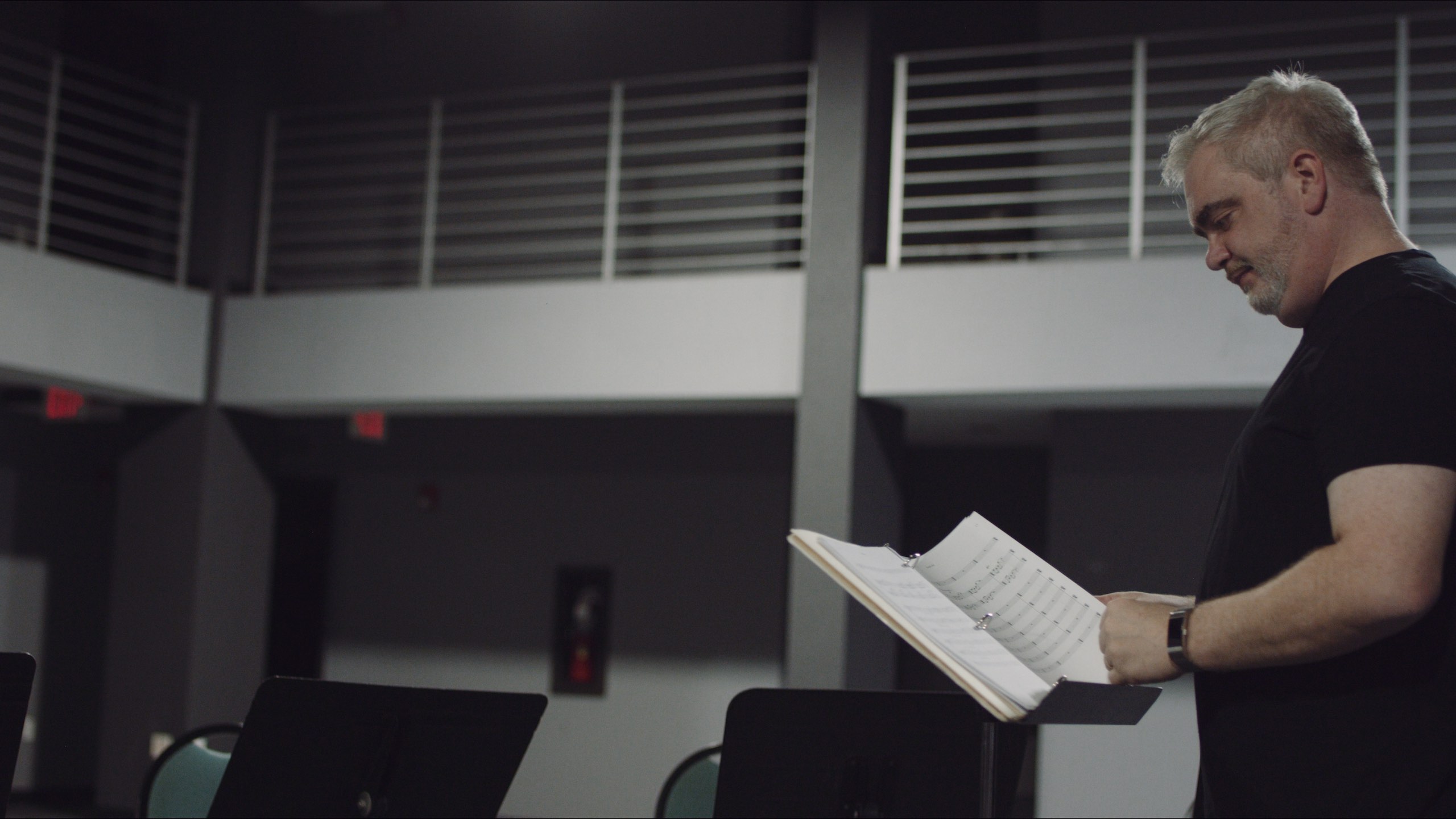 Christmas Eve The Score, The Dailies Season 2 Episode 12 with side profile of music conductor looking at music sheets