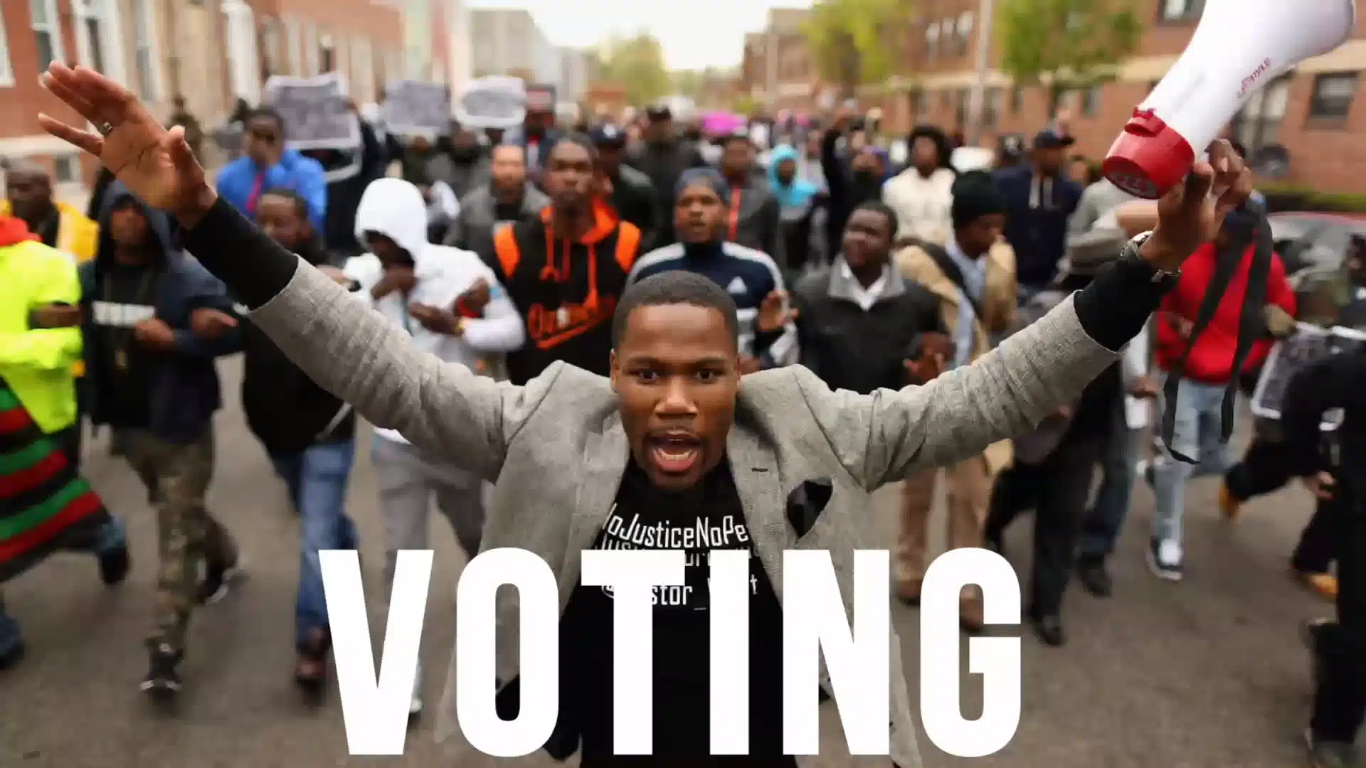 76 Words and Collective PAC, We Voting political ad with white letters Voting on backdrop of crowd of protesters with African American man leading holding a red and white bullhorn